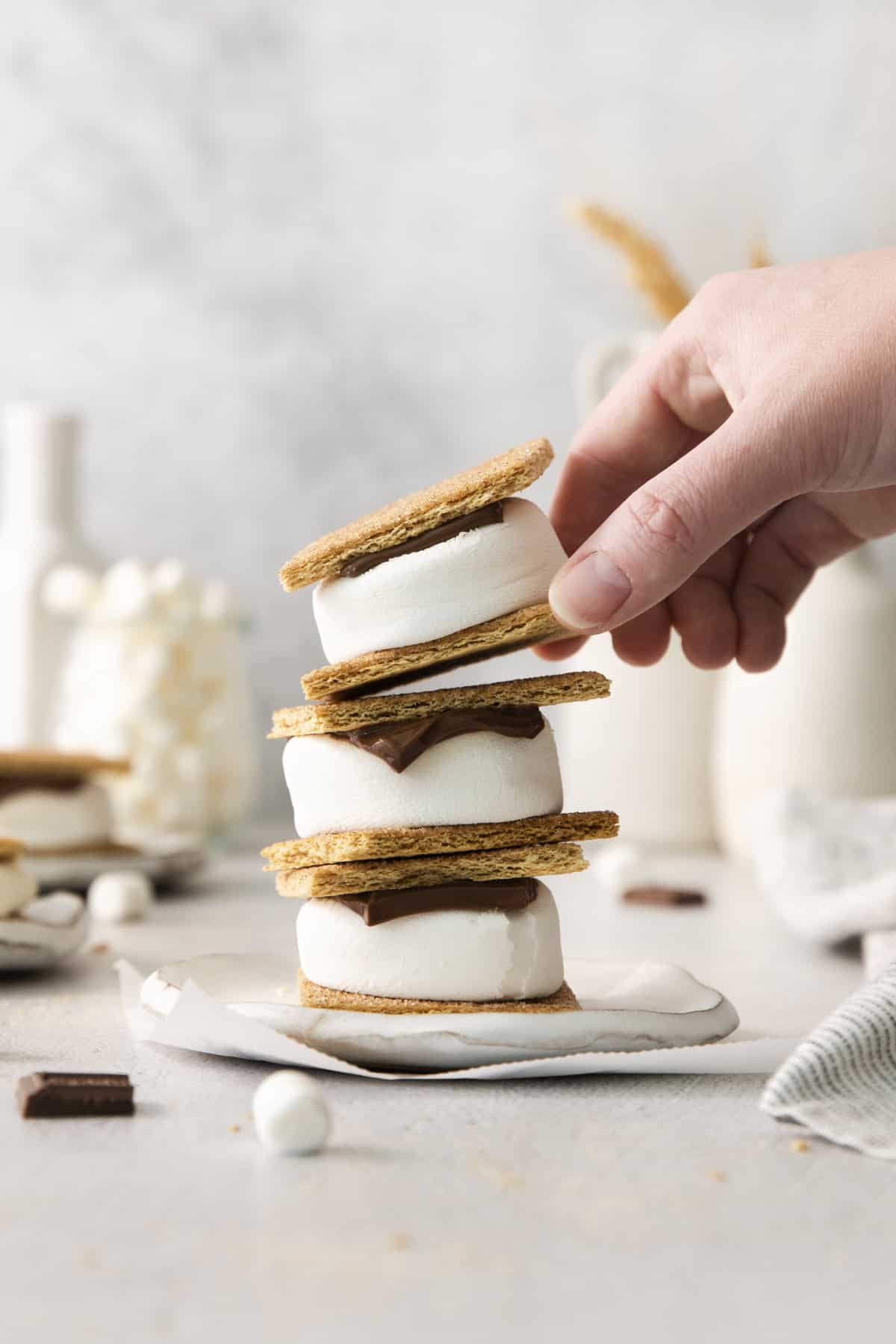 three air fryer s'mores stacked, with the top one being lifted off.