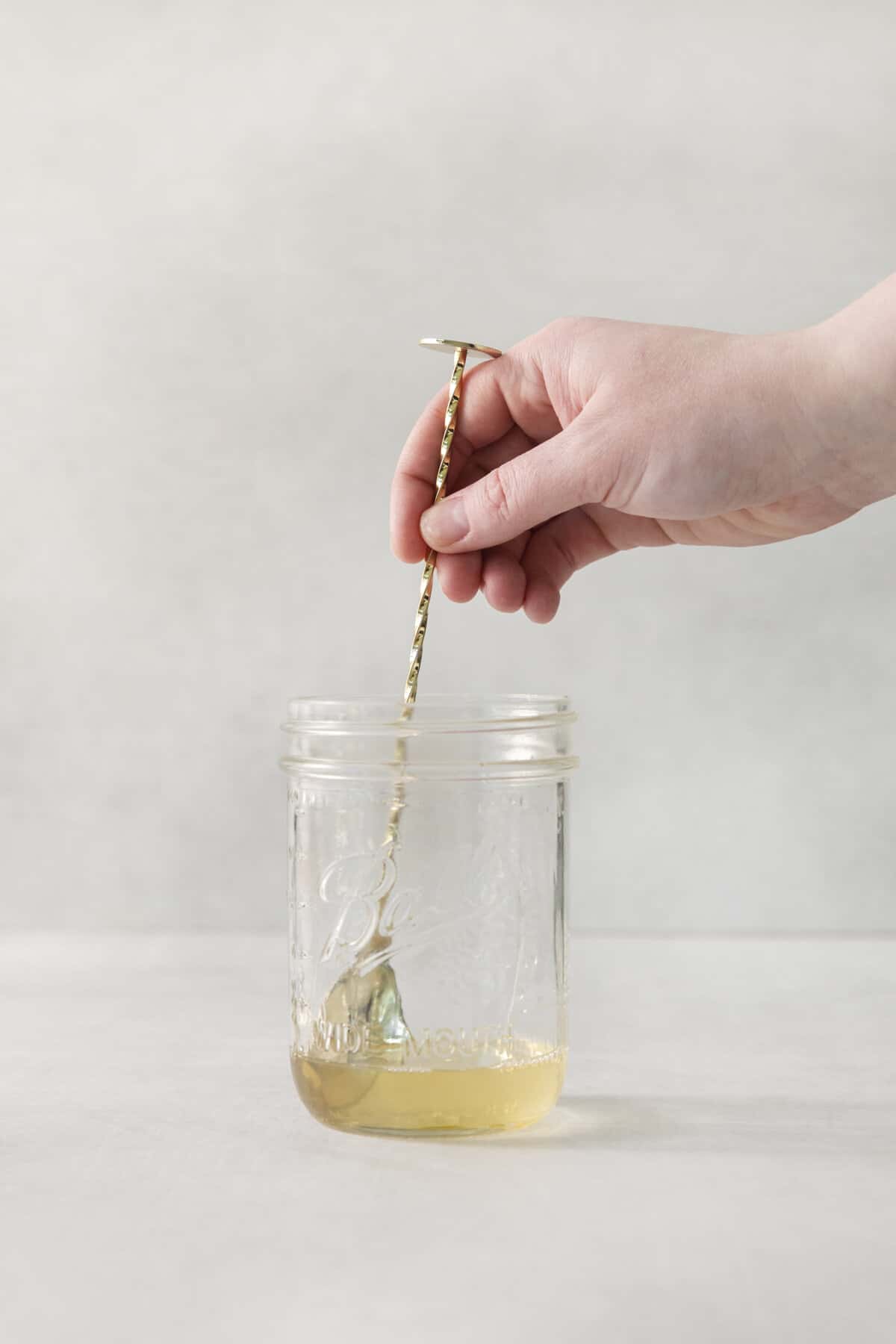 honey and vodka being mixed together.