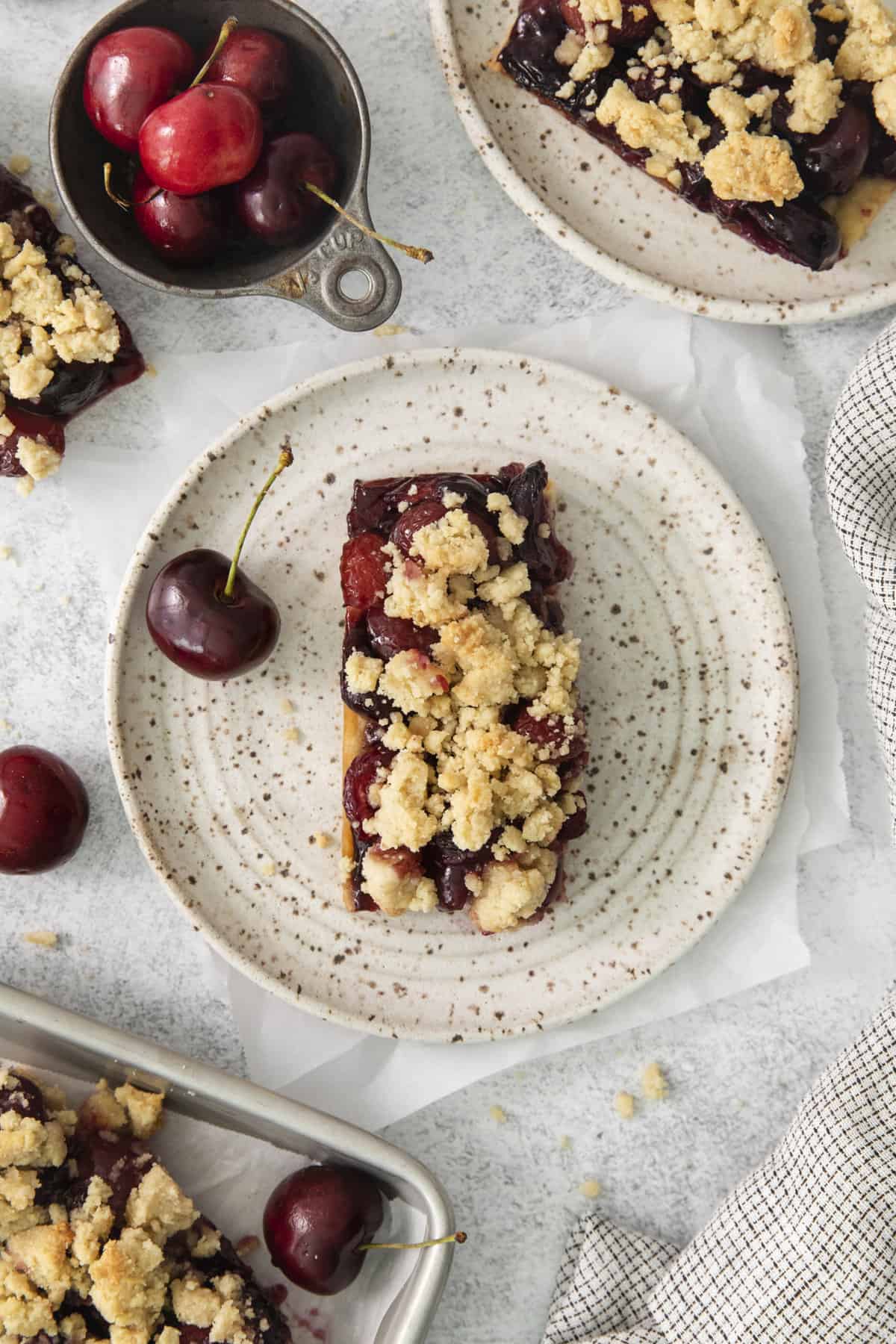 overhead of a rectangular slice of a cherry pie bar on a plate.