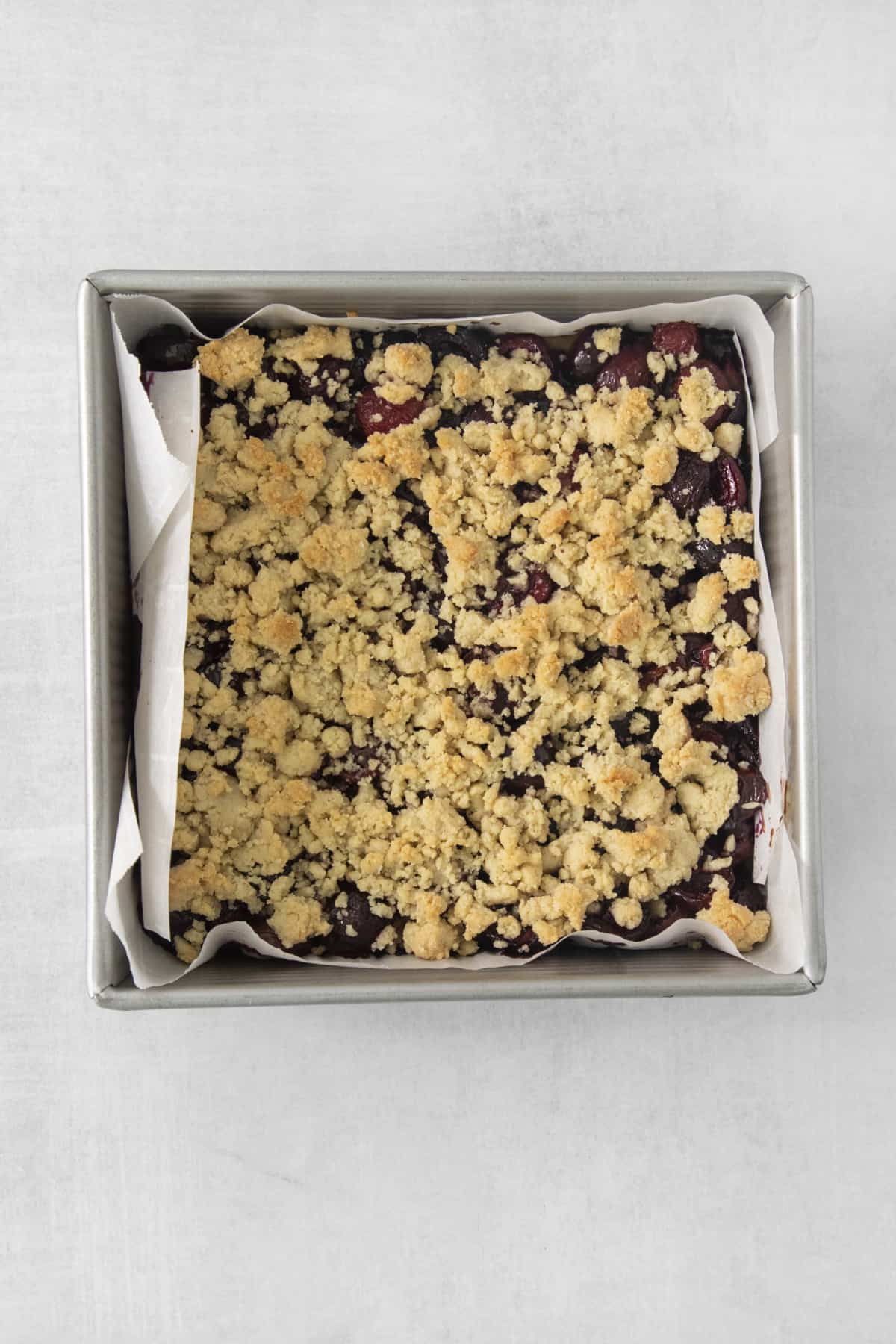 assembled and baked cherry pie bars in a baking dish.