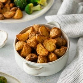 a bowl piled with roasted potatoes.