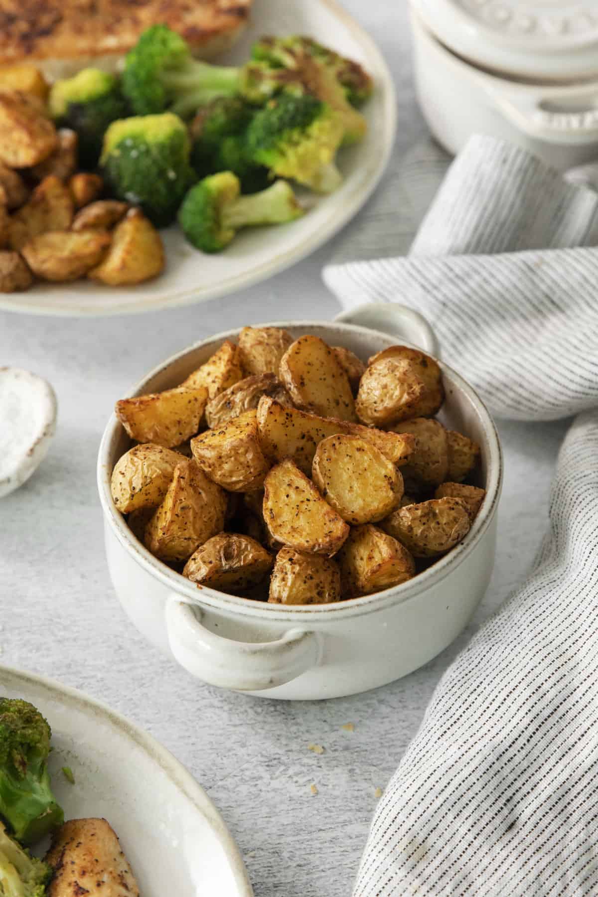 a bowl piled with roasted potatoes.