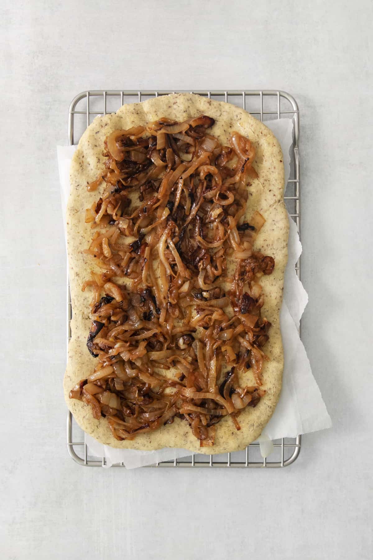 caramelized onions layered on a pizza crust.