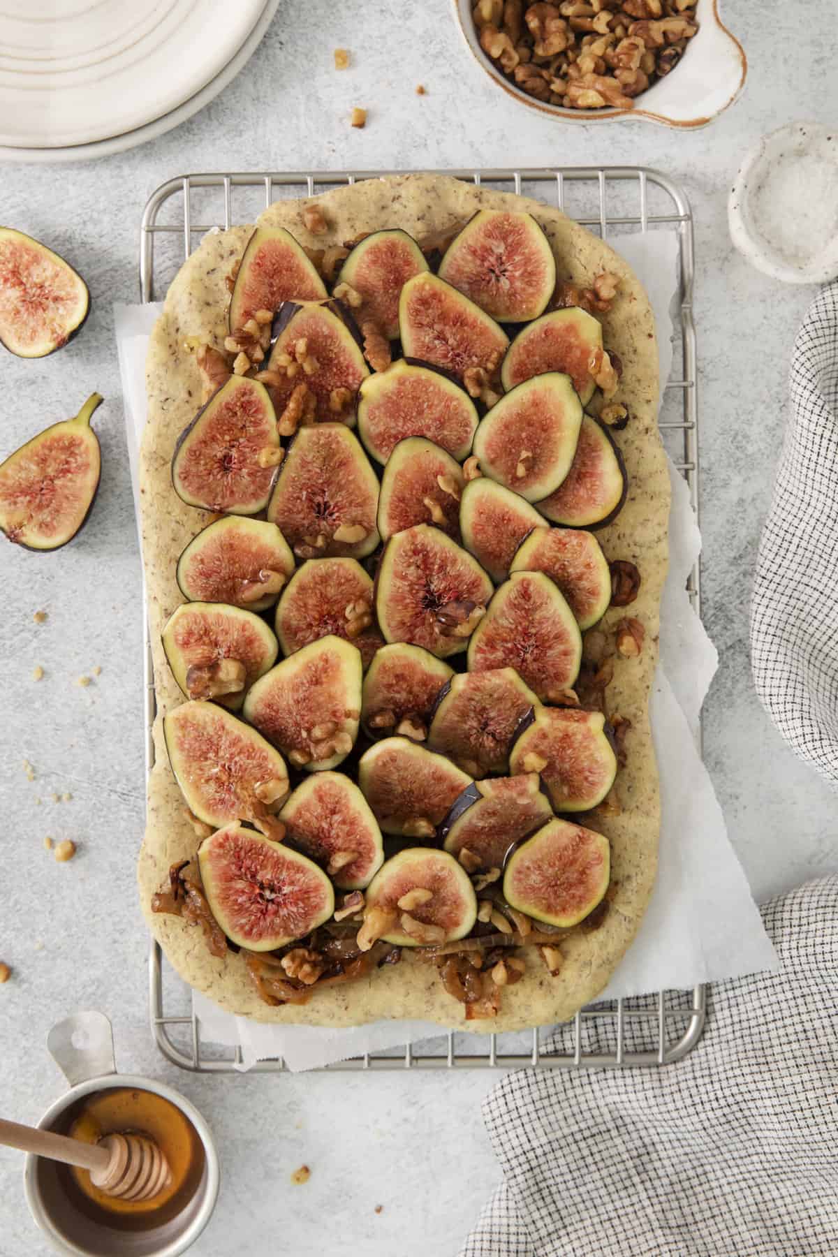 overhead of a fig pizza on a cooling rack.