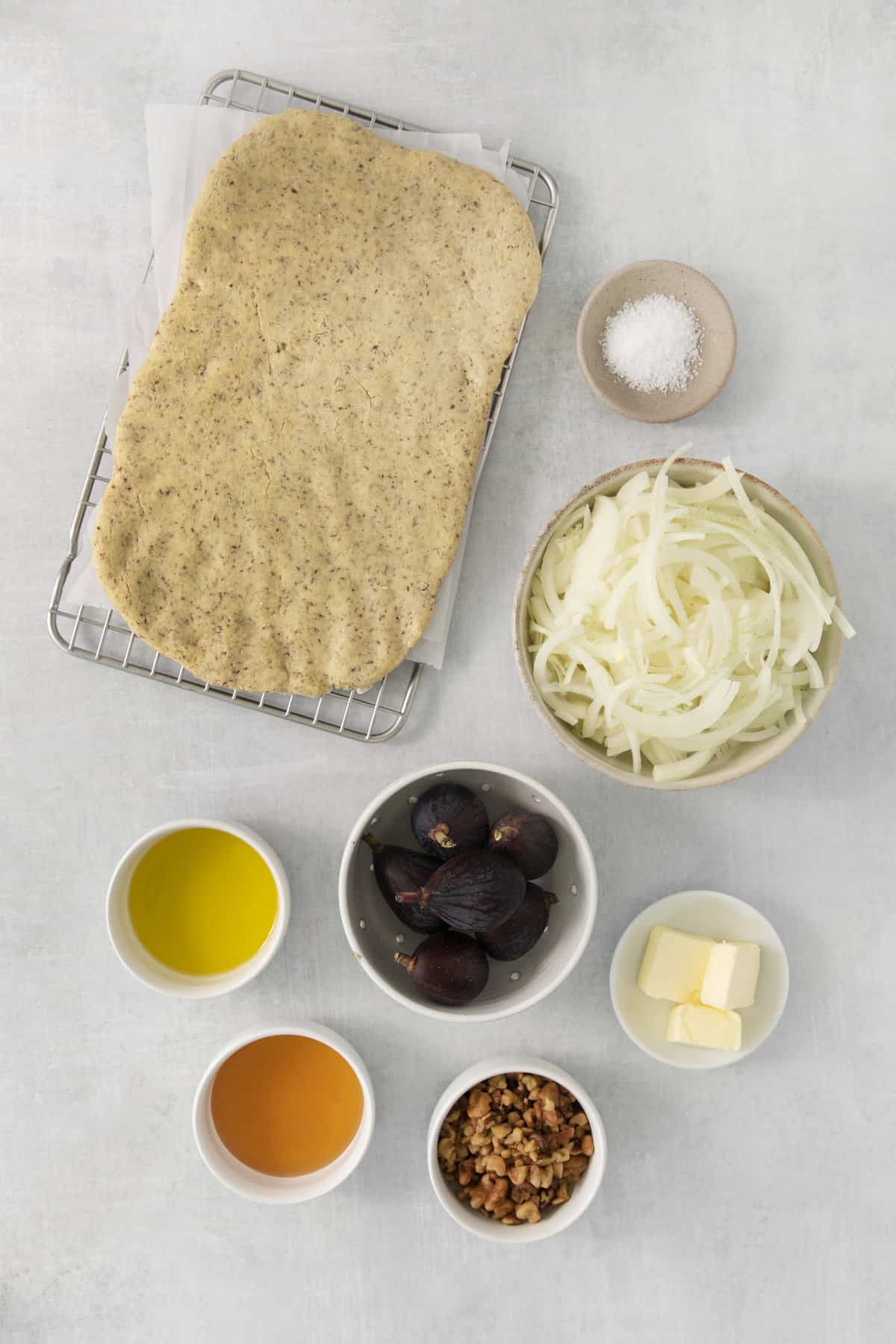 overhead of gluten free fig pizza ingredients in separate dishes.