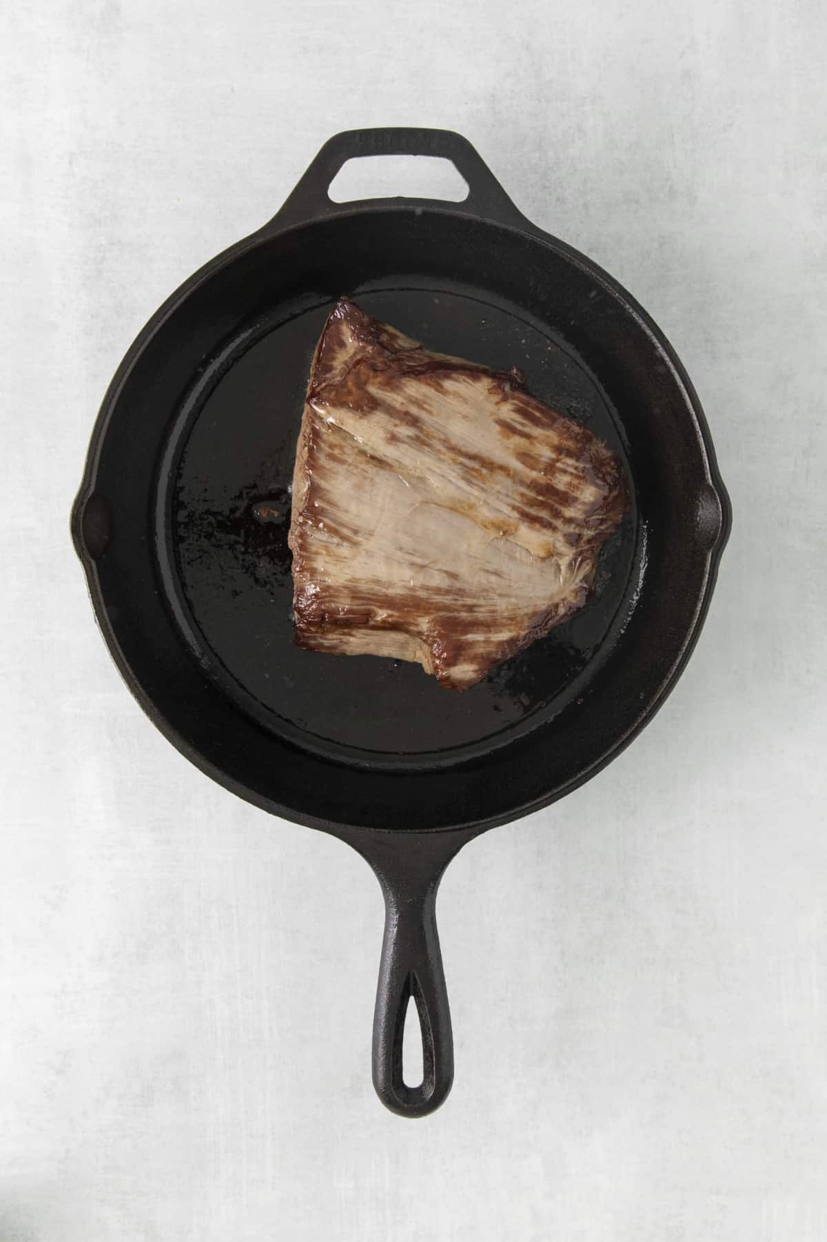 steak in a skillet.
