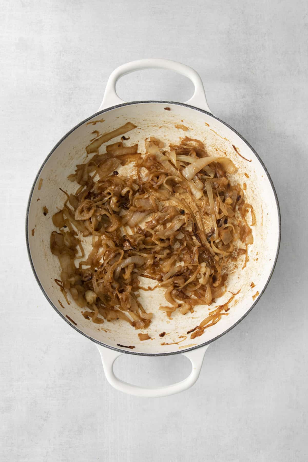 onions being caramelized in a pan.