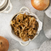 overhead of a bowl filled with cooked onions.