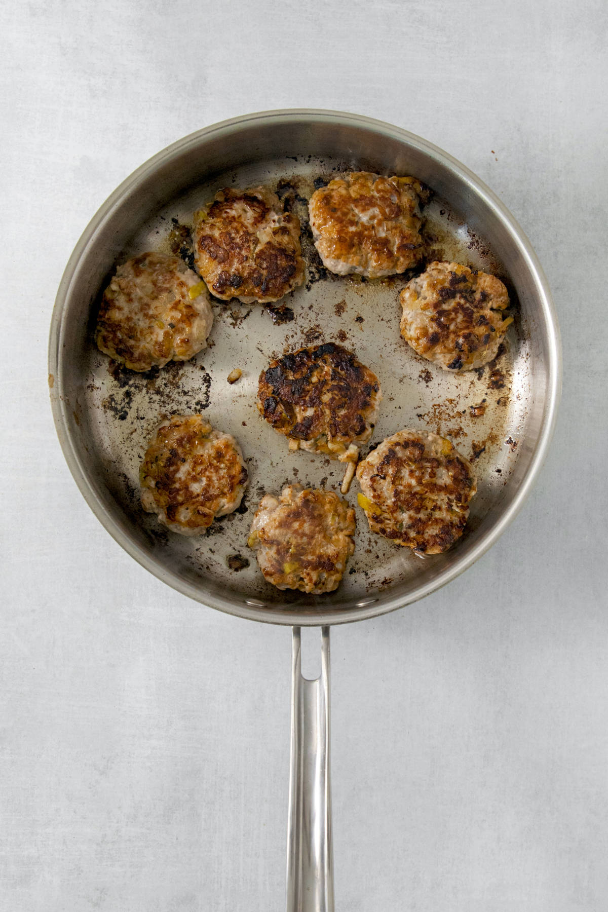cooked sausage patties in a skillet.