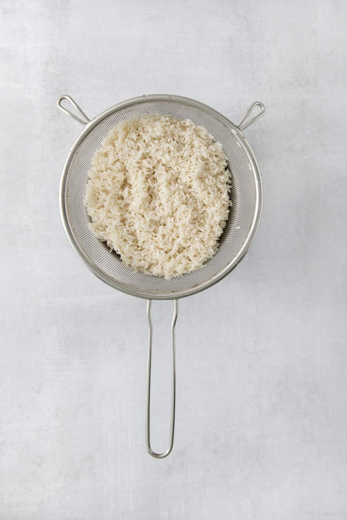 rinsed rice in a sieve.