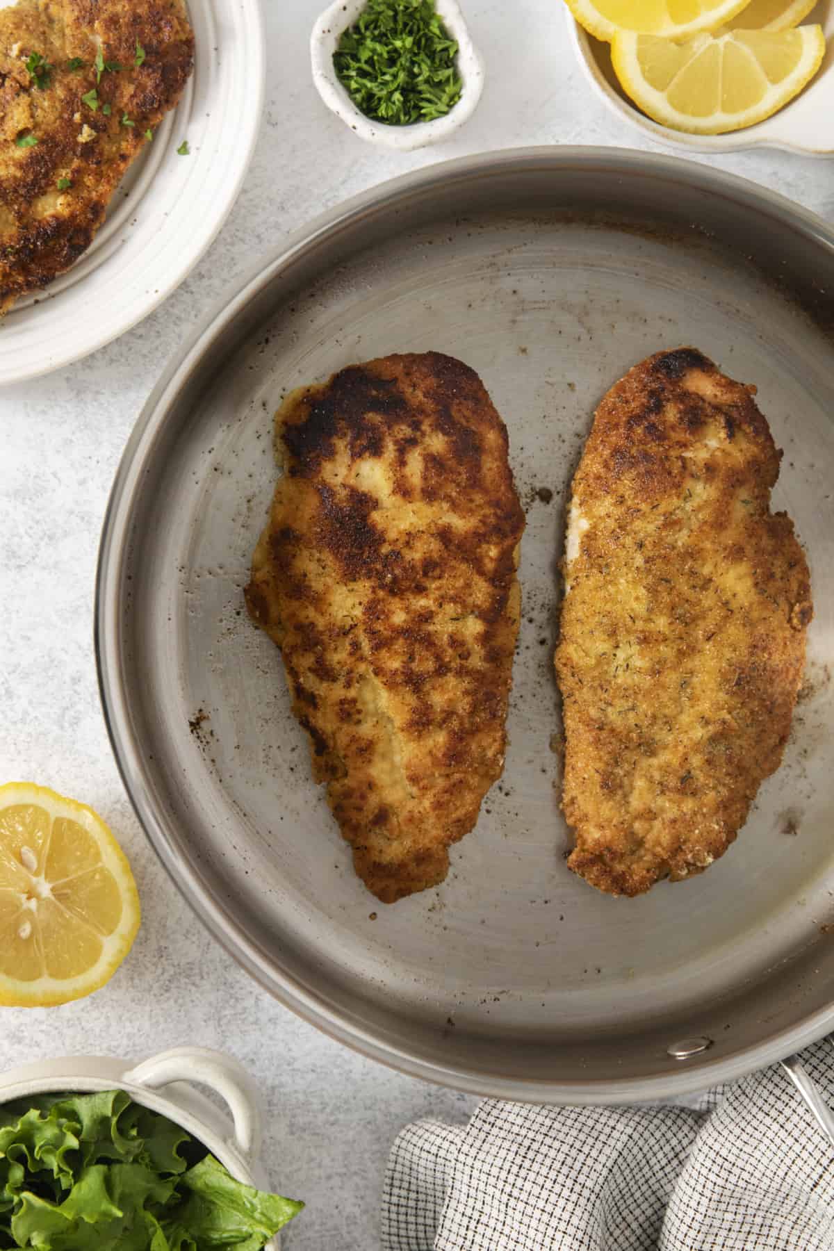 chicken cutlets fried in a pan.