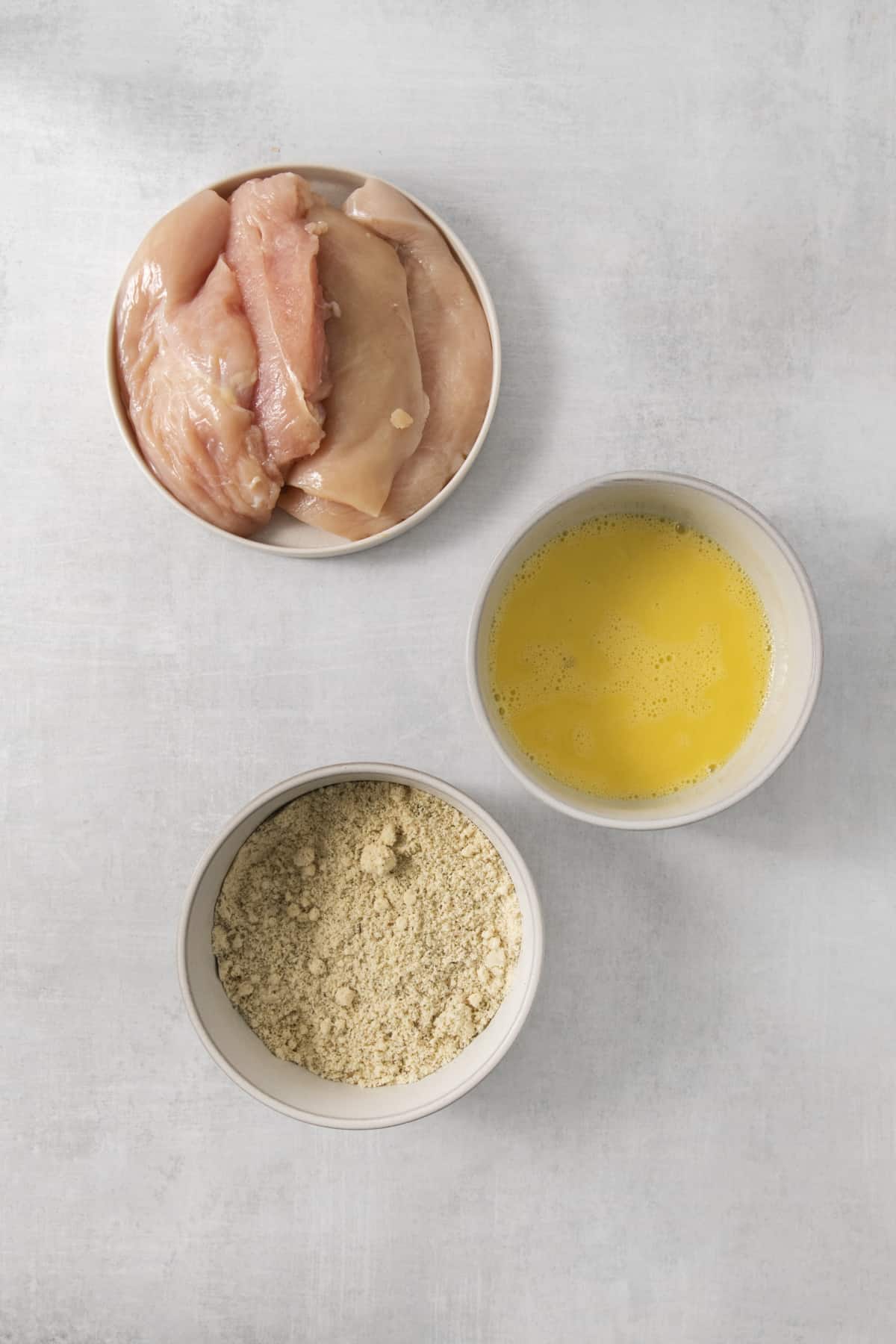 chicken cutlet ingredients in separate dishes.