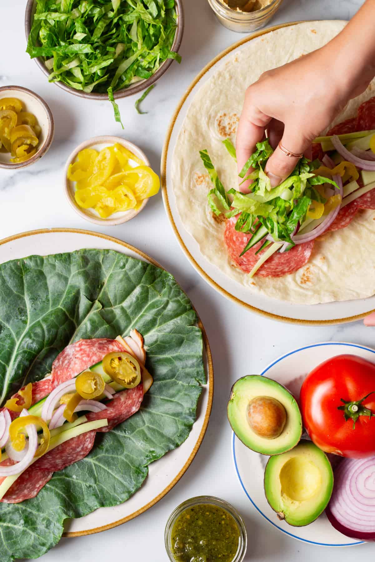 pinwheel sandwiches being assembled, one in a lettuce wrap and the other in a tortilla.