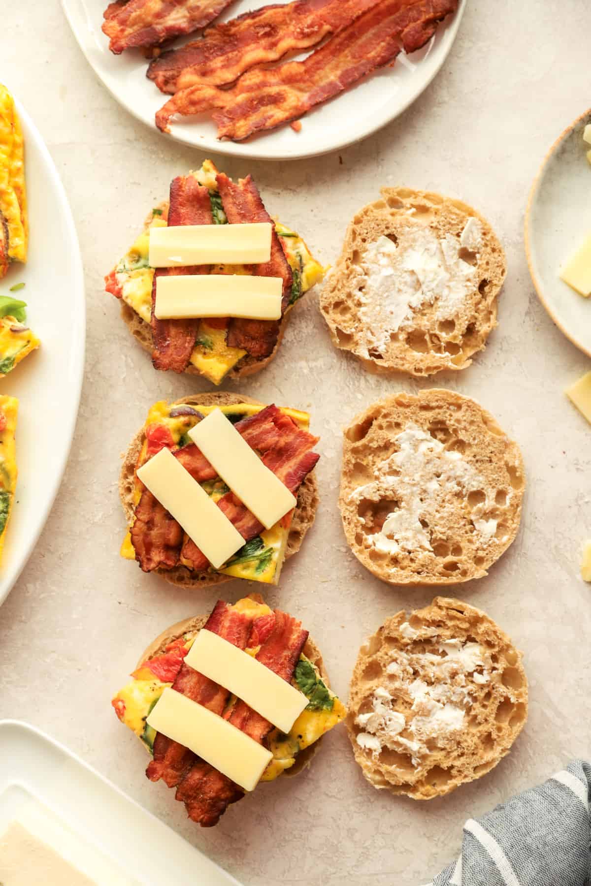 freezer breakfast sandwiches being layered with toppings.