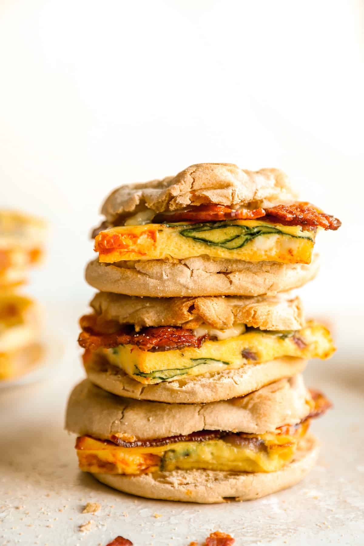 three assembled breakfast sandwiches stacked. 