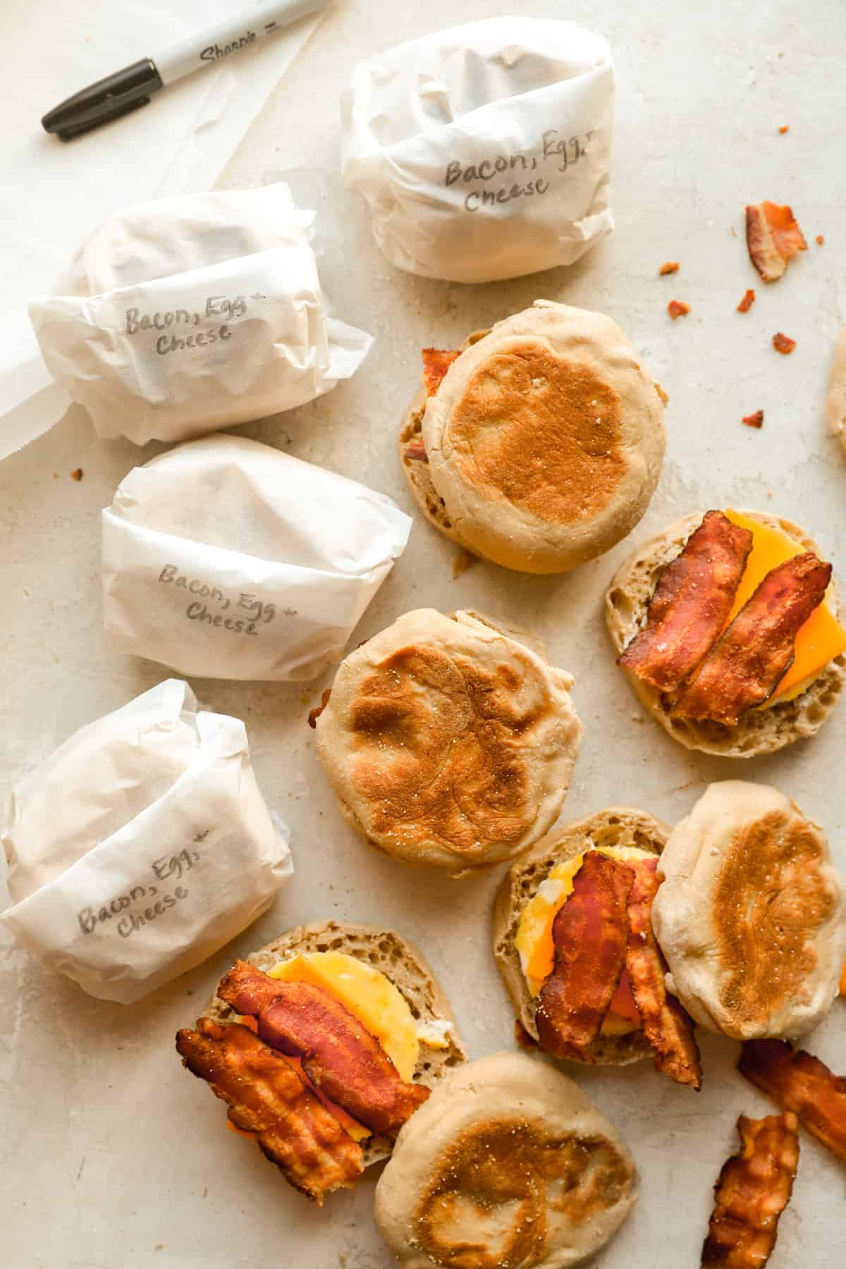 above image of freezer breakfast sandwiches being wrapped with parchment paper.