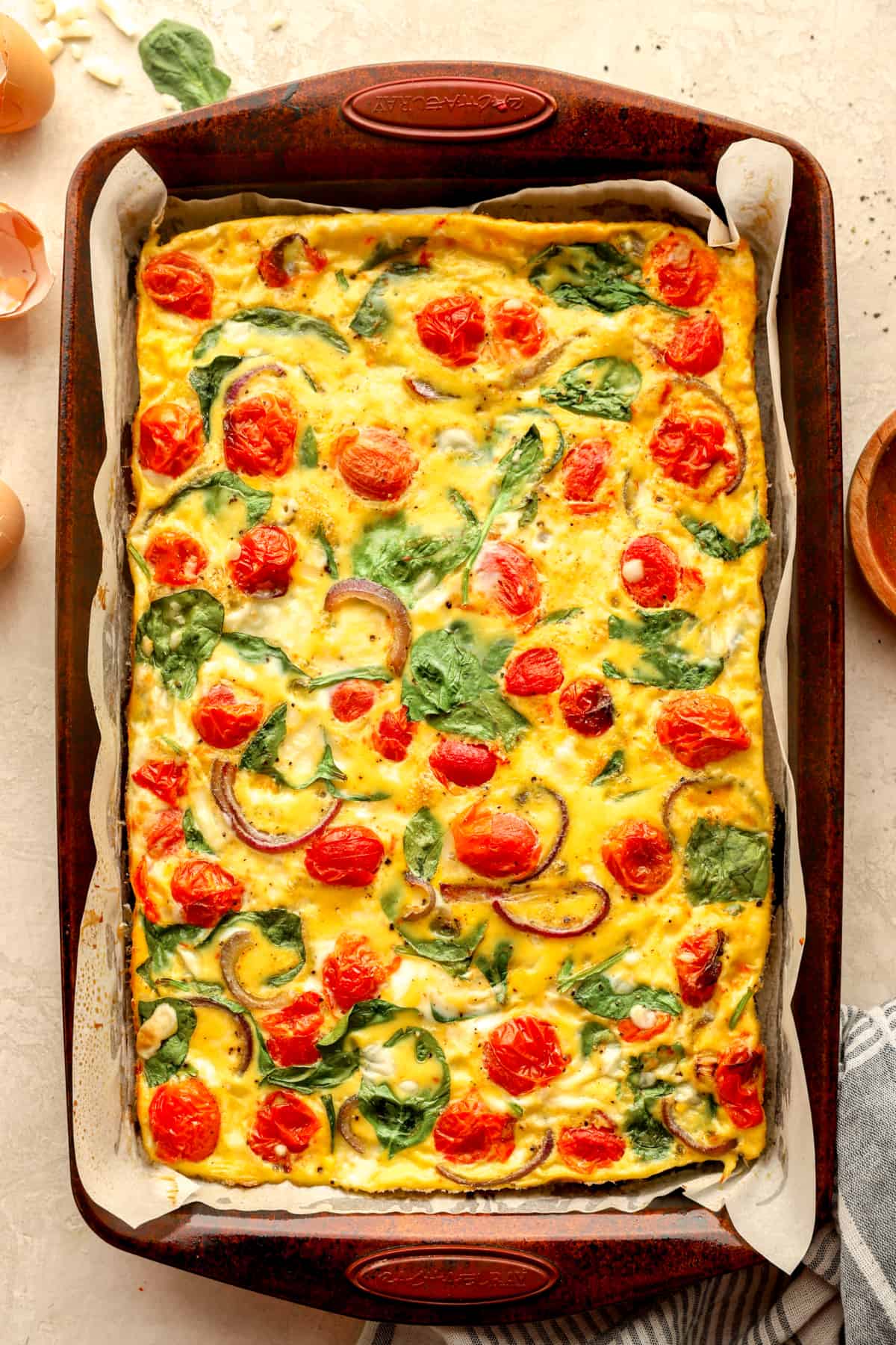 Finished Baked Sheet Pan Eggs with Spinach and Tomatoes.