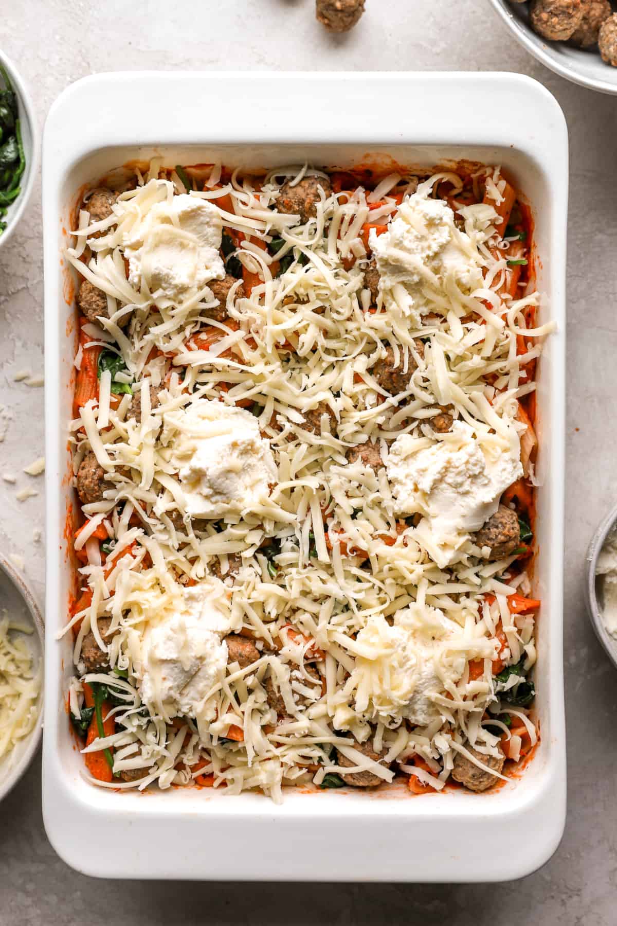 pasta topped with cheese in a baking dish.