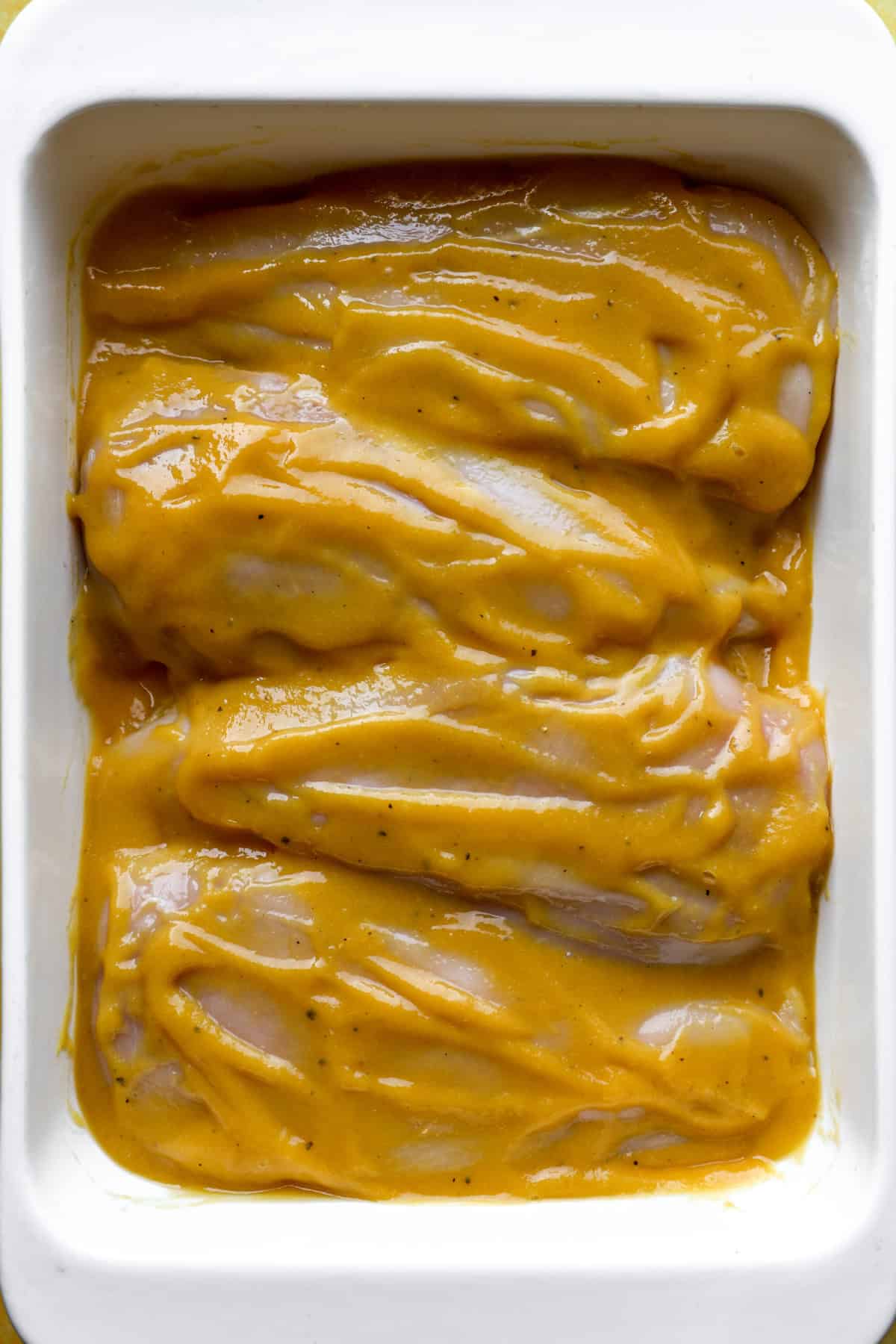 Raw chicken breasts marinating in pureed mango salsa. 