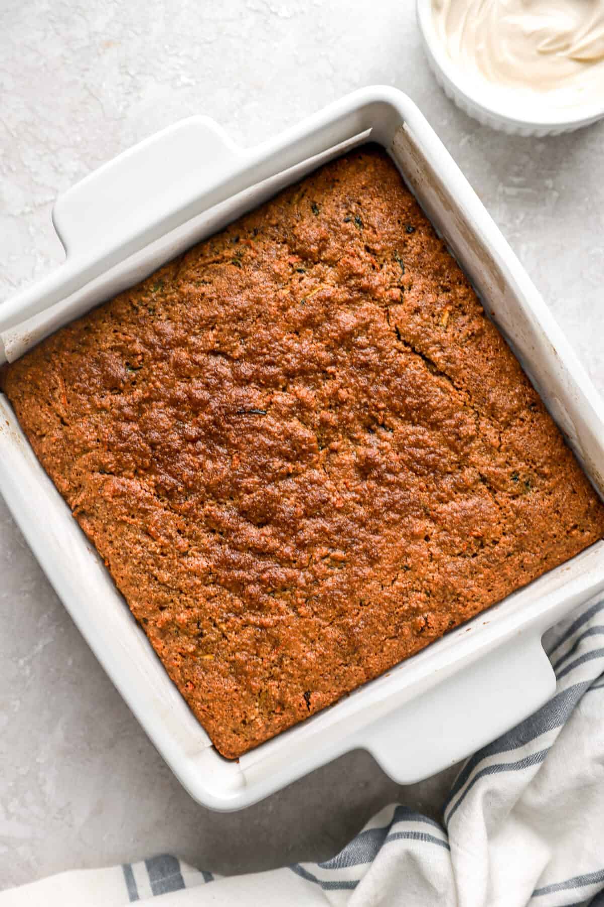 Baked carrot zucchini bars in a white 8x8 pan. 