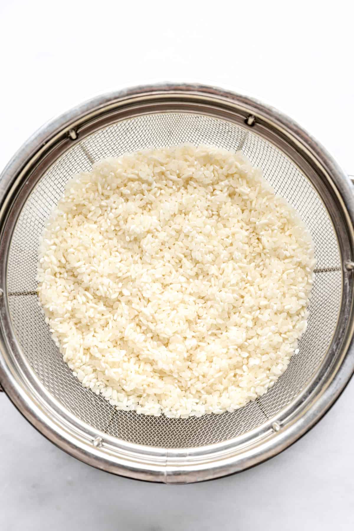 rinsed rice in a strainer from above.