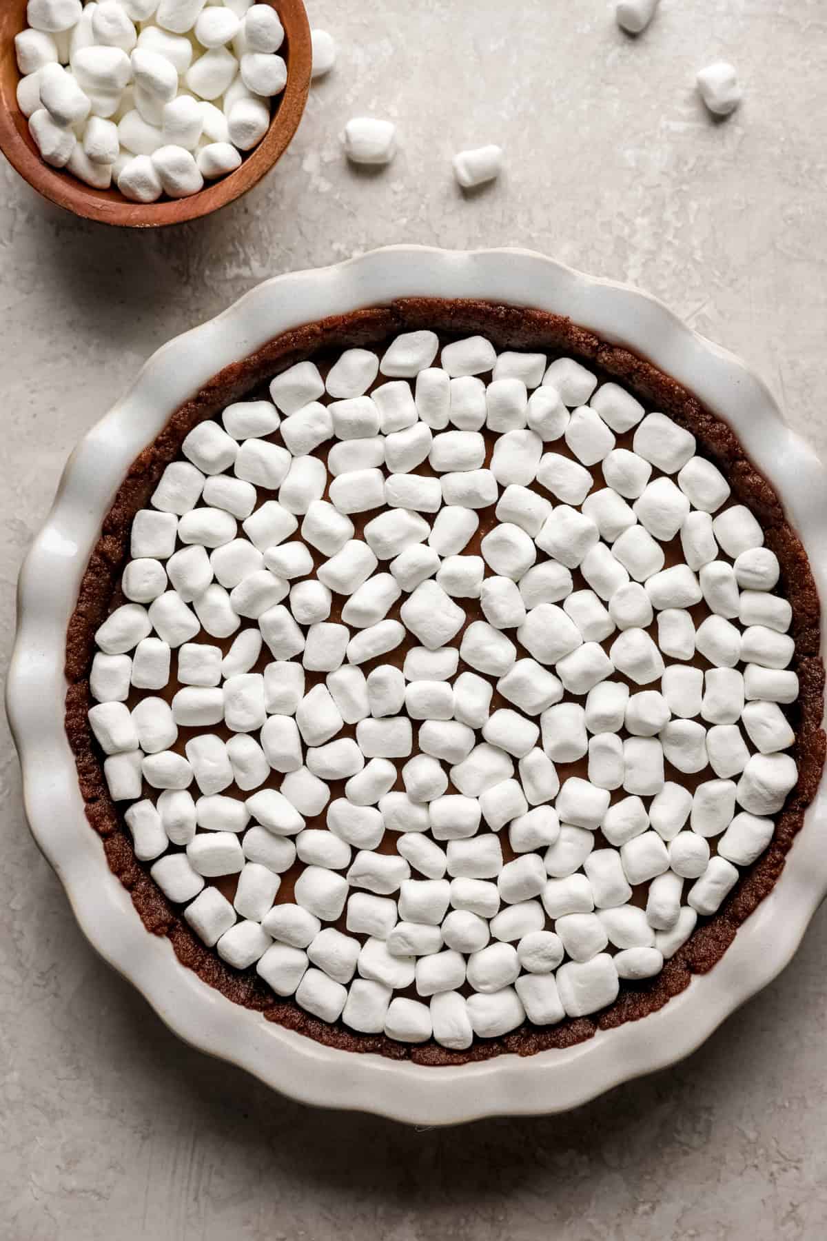 Raw marshmallows over a s'mores pie. 