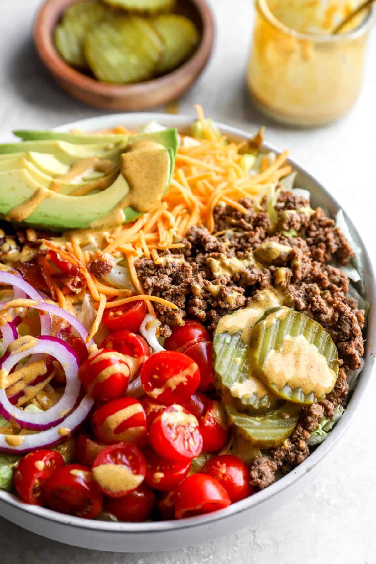 Side view of a cheeseburger salad bowl. 