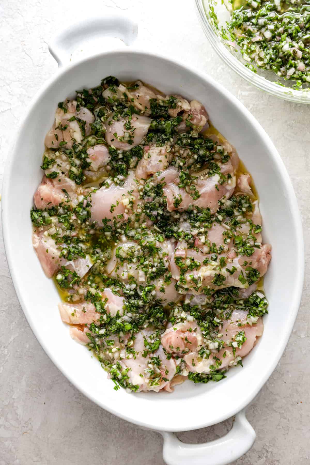 Chicken marinating in chimichurri sauce.