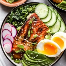 A grill salmon bowl with garlicky kale.