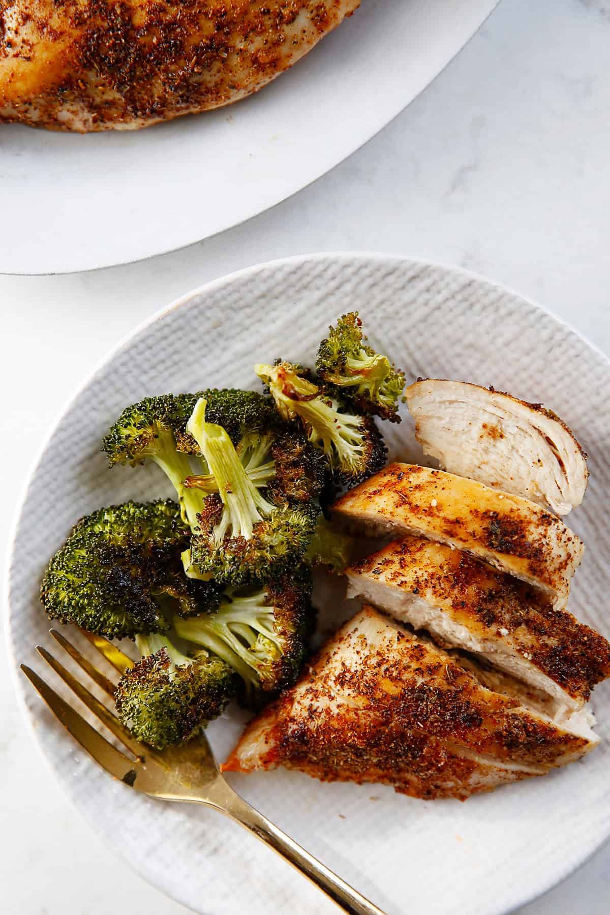 A plate of air fryer chicken breast and broccoli. 