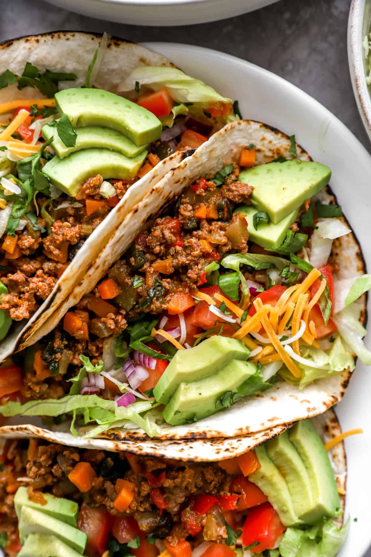 Close up image of tacos with Instant Pot taco meat and toppings. 