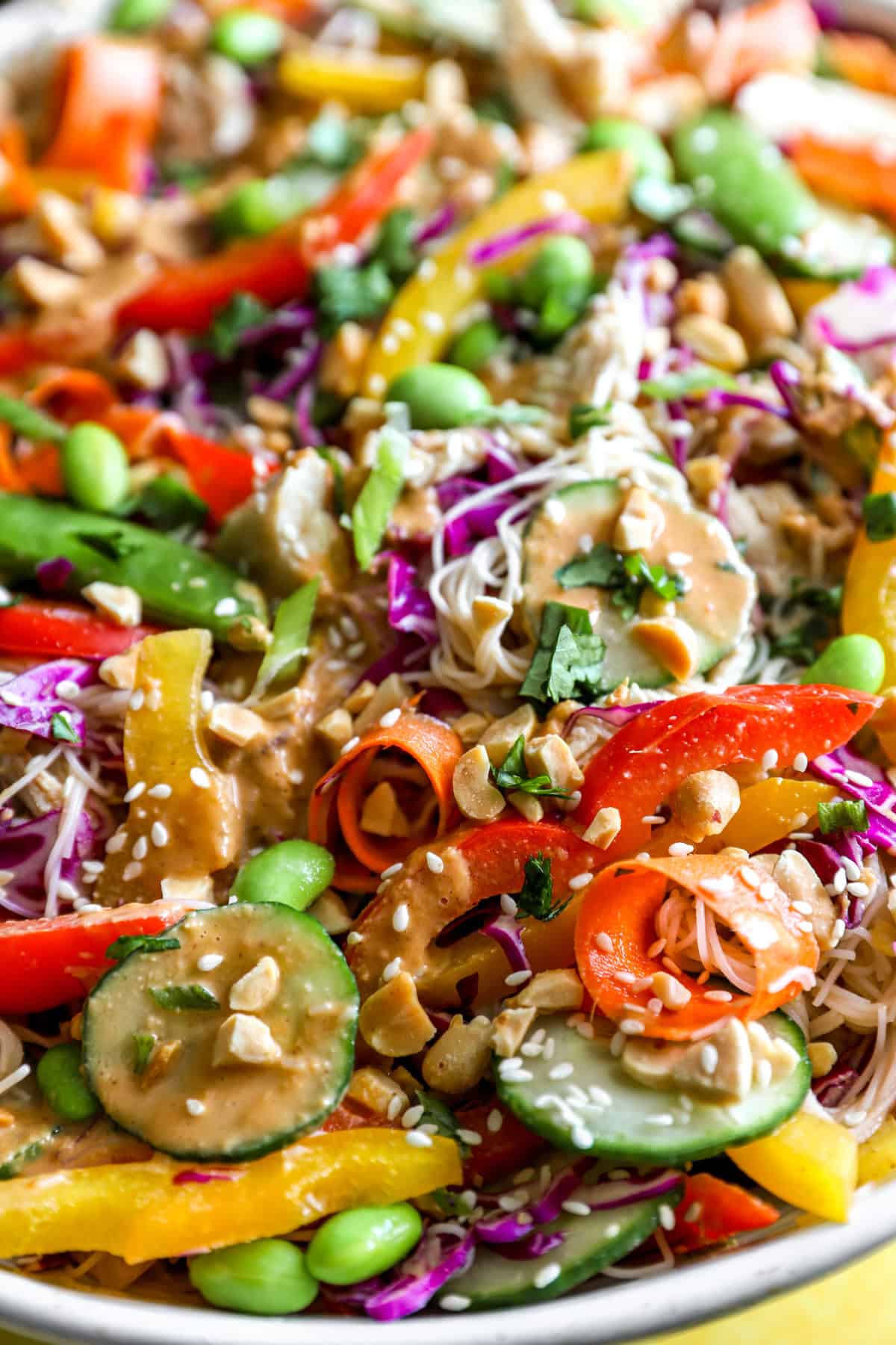 An upclose shot of veggies and dressing for asian noodle salad