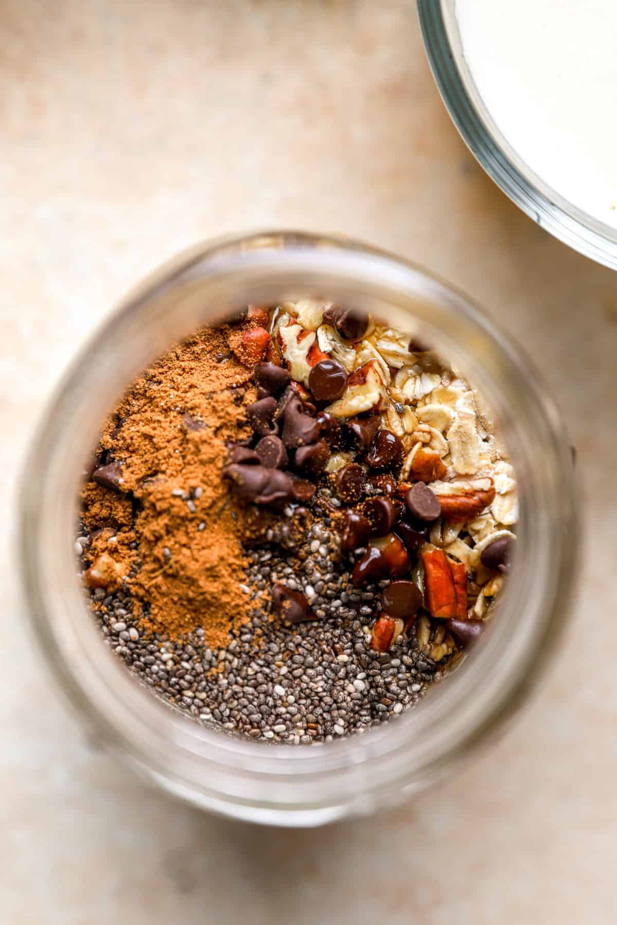 Overhead image of ingredients for pumpkin overnight oats in a jar. 