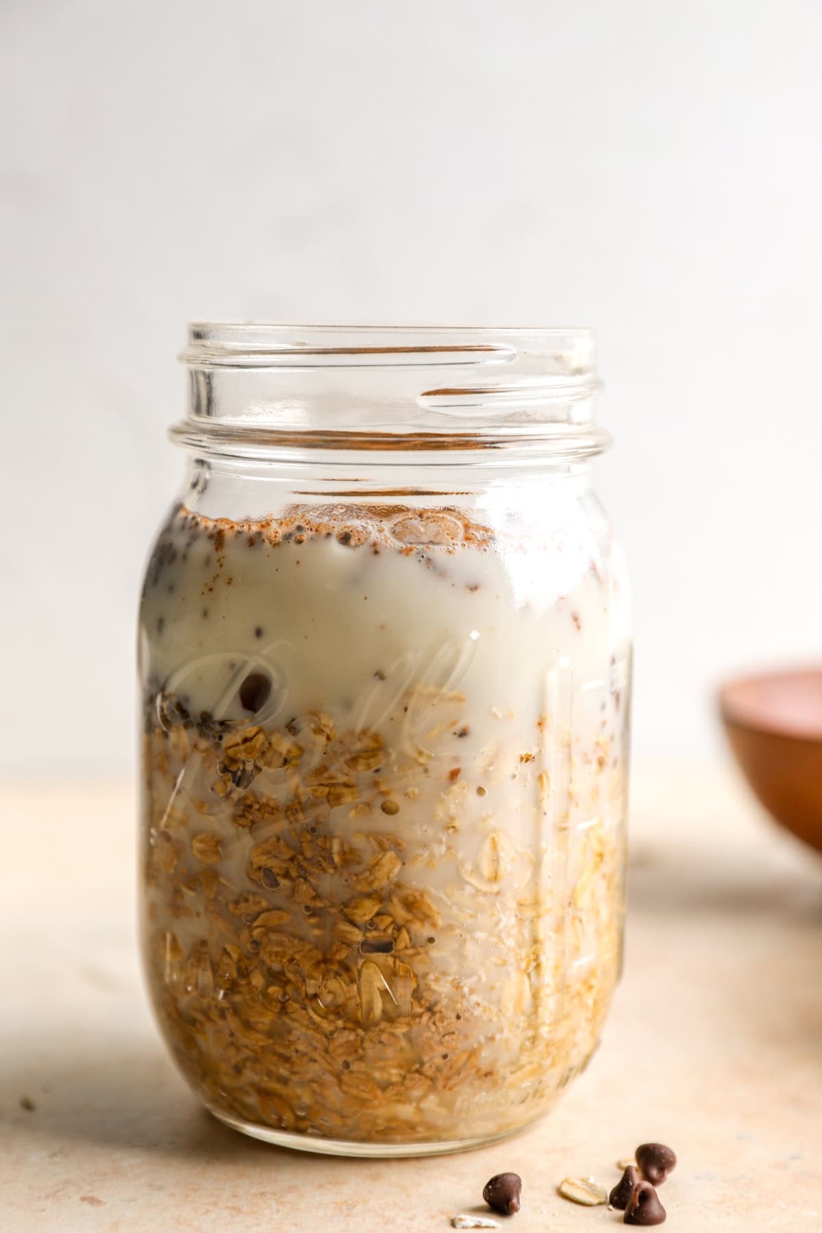 Side view of a jar of pumpkin overnight oats. 