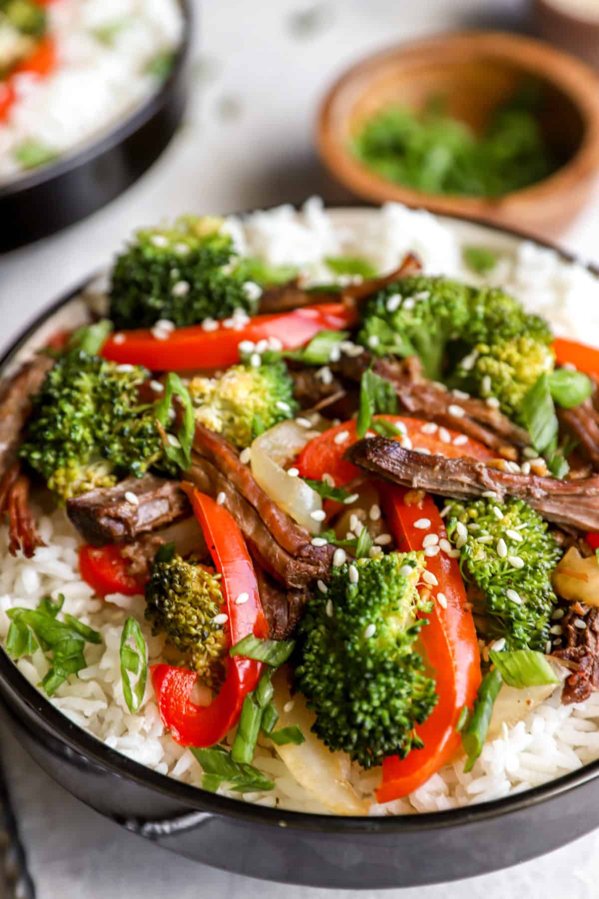 Side view of a bowl of Paleo beef, broccoli, peppers, and rice.