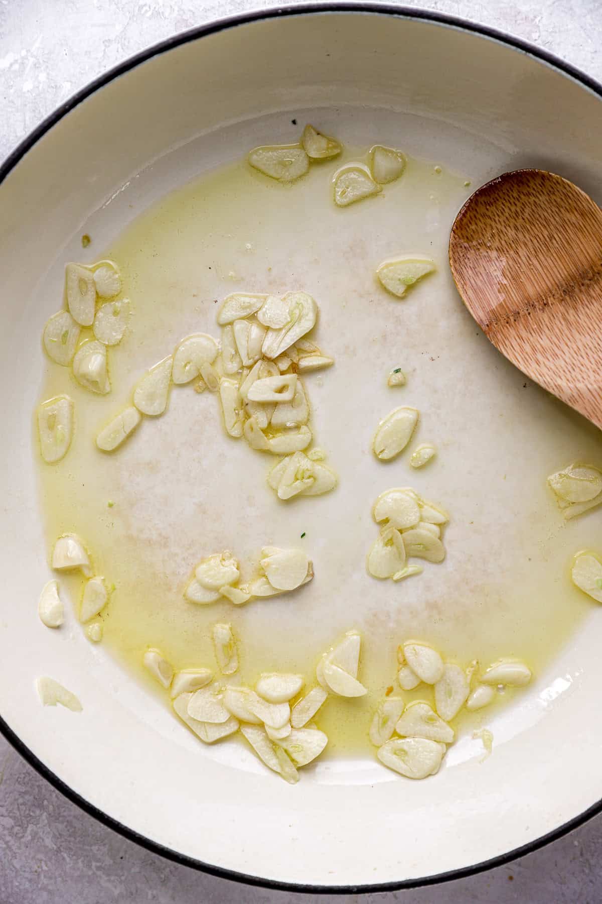 Shallots sautéing in ghee in a pan. 