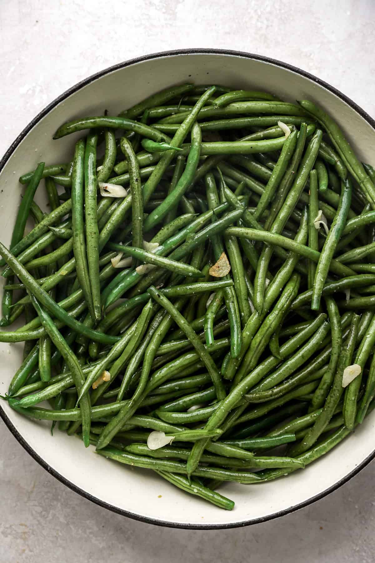 Green beans sautéing in a skillet. 