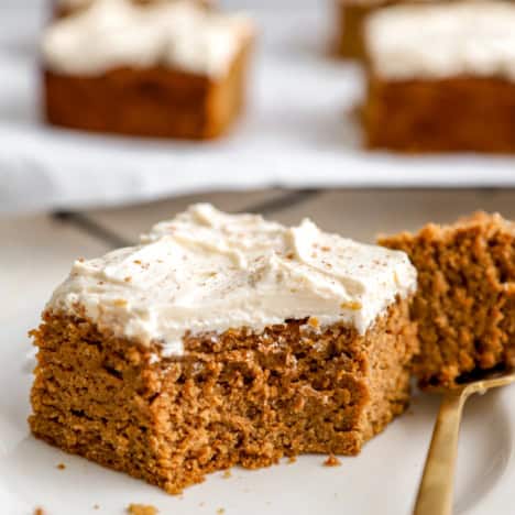 A slice of gluten free pumpkin cake with a bite missing.