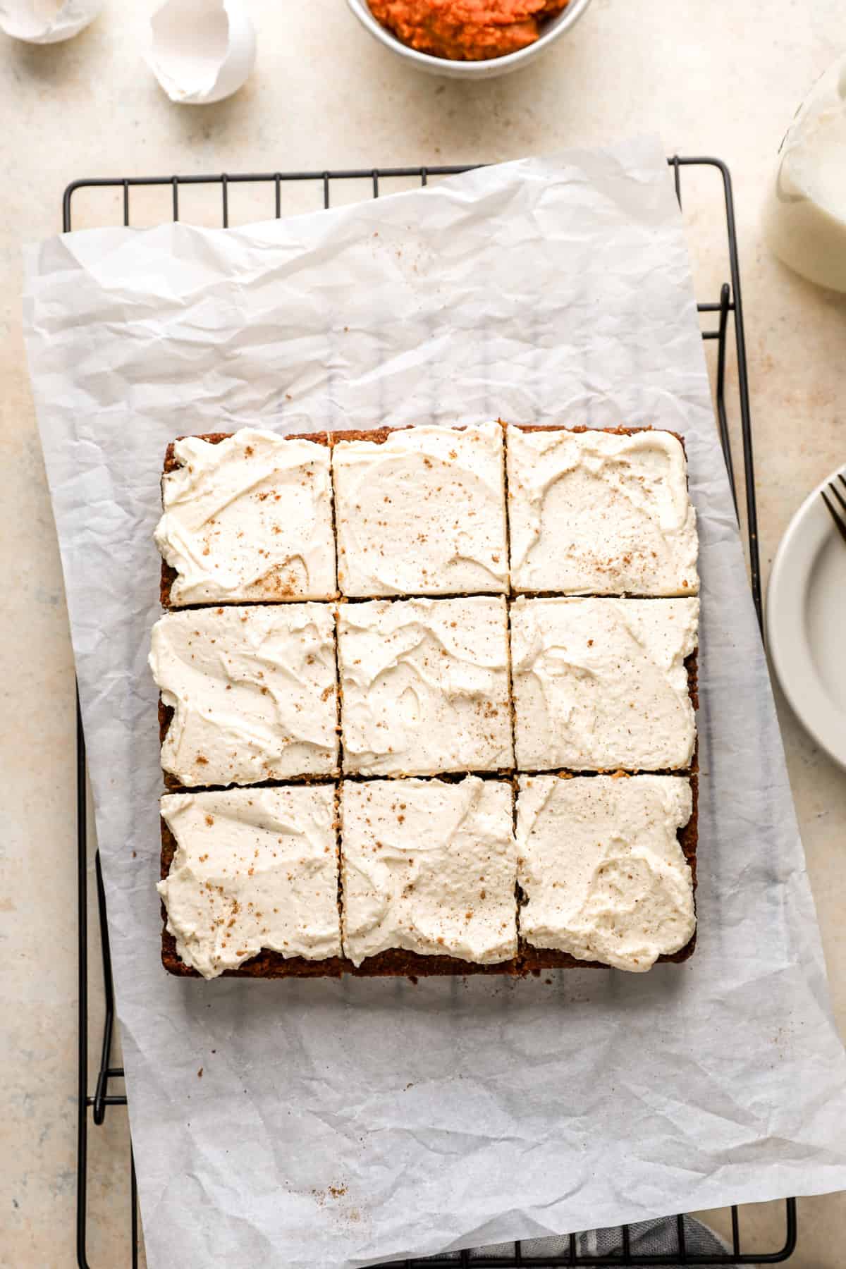 Overhead image of gluten free pumpkin cake sliced into 9 pieces. 