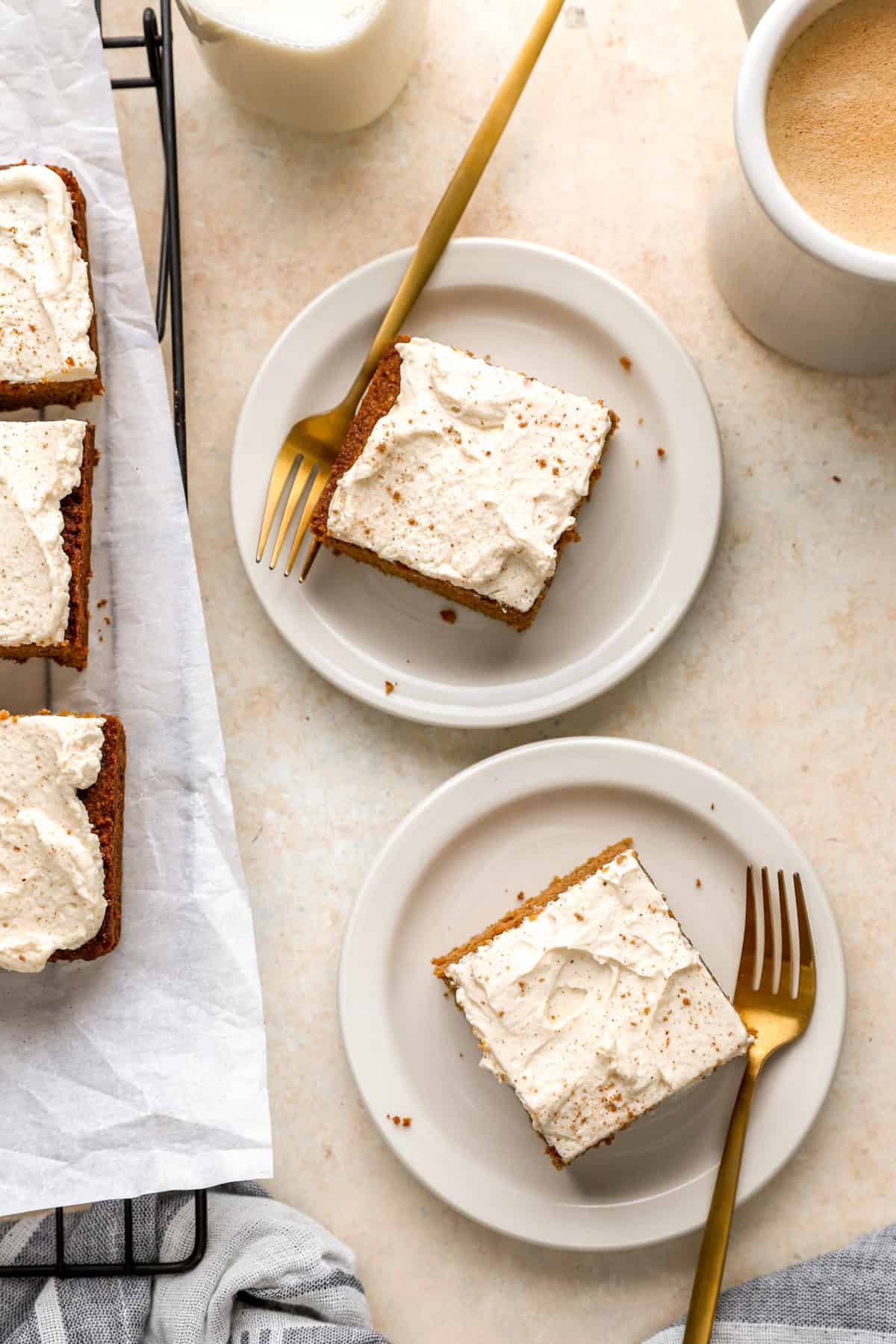 Overhead image of two plates with a slice of pumpkin cake.