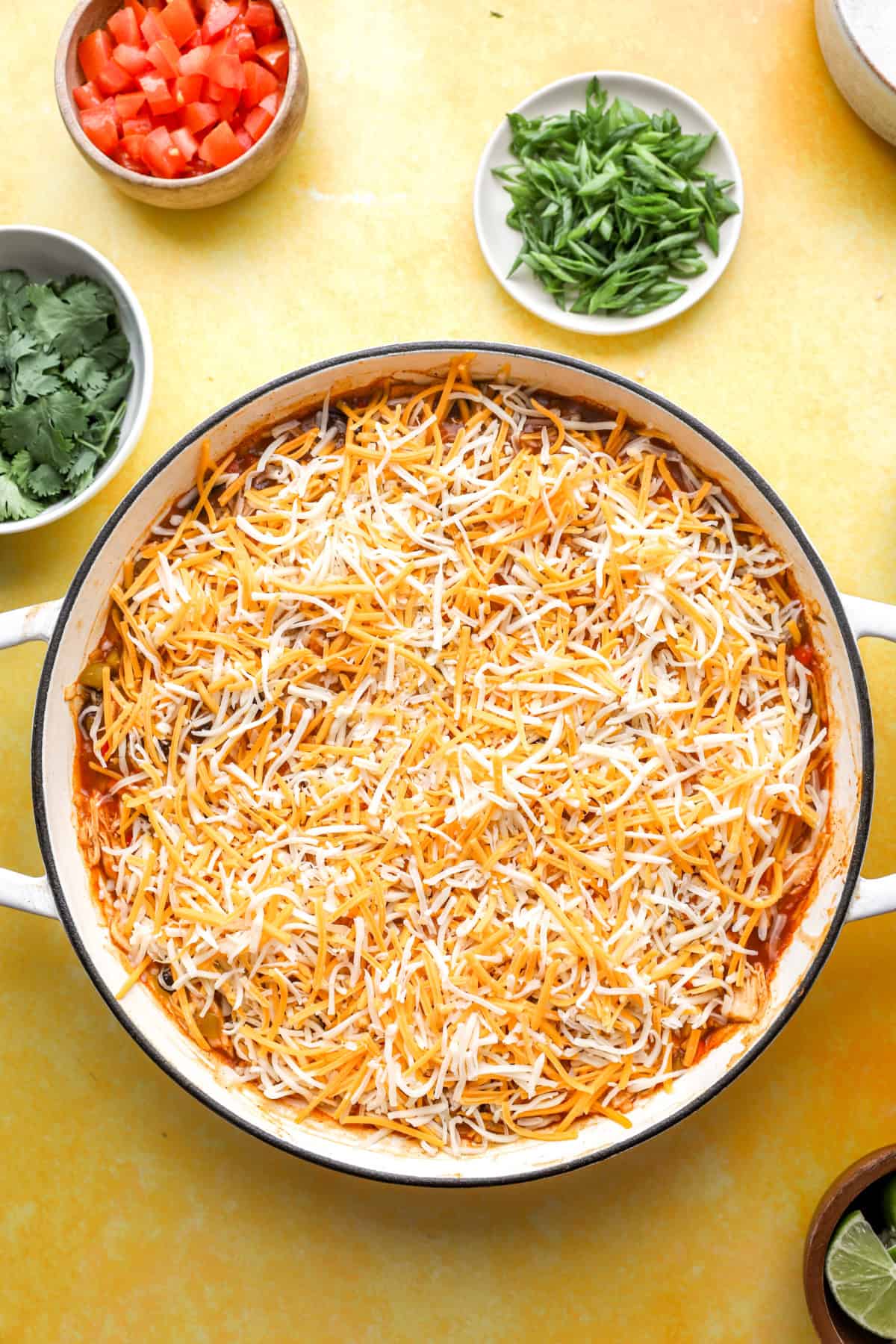 A chicken enchilada skillet topped with cheese.