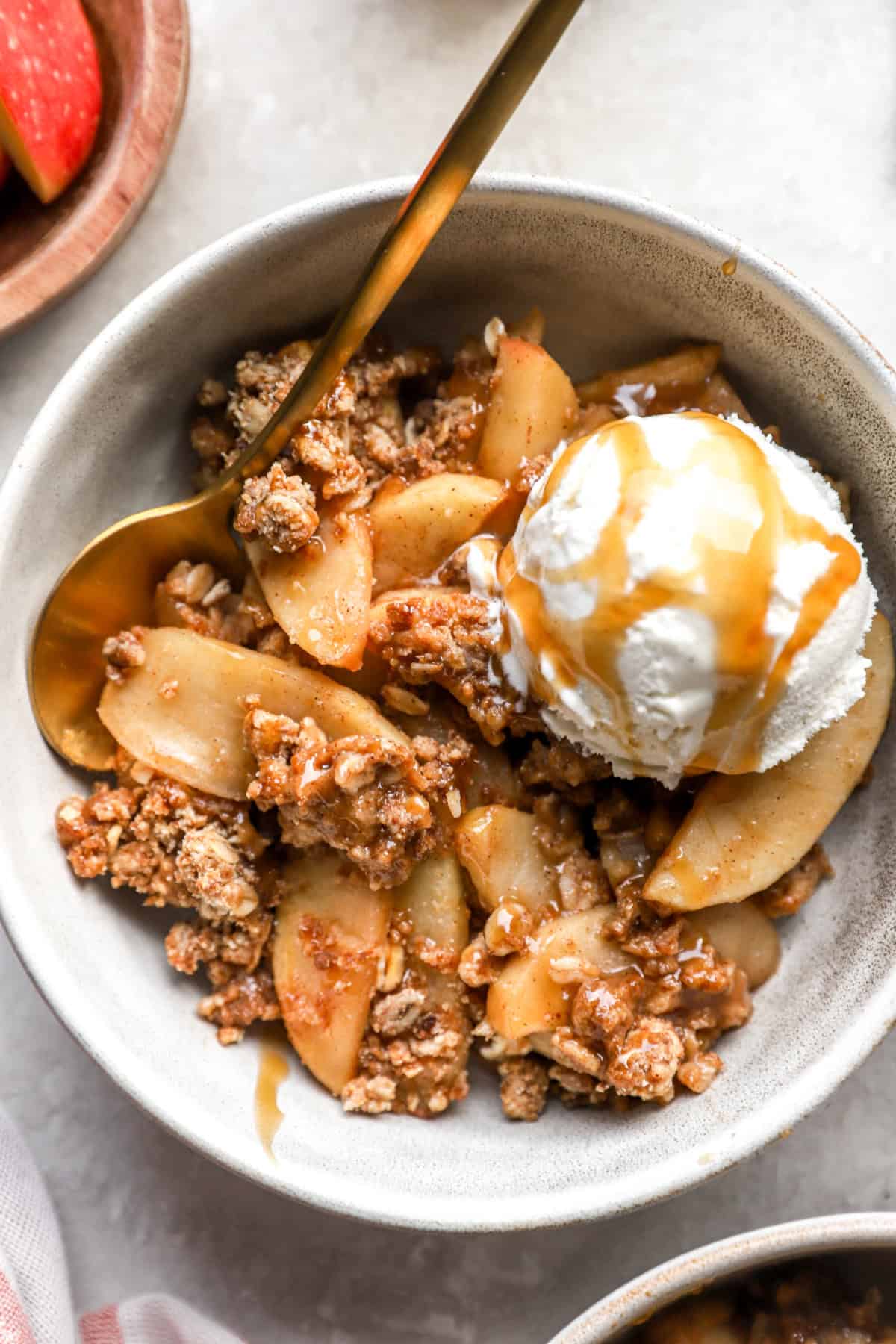 A bowl of easy apple crisp with a spoon. 