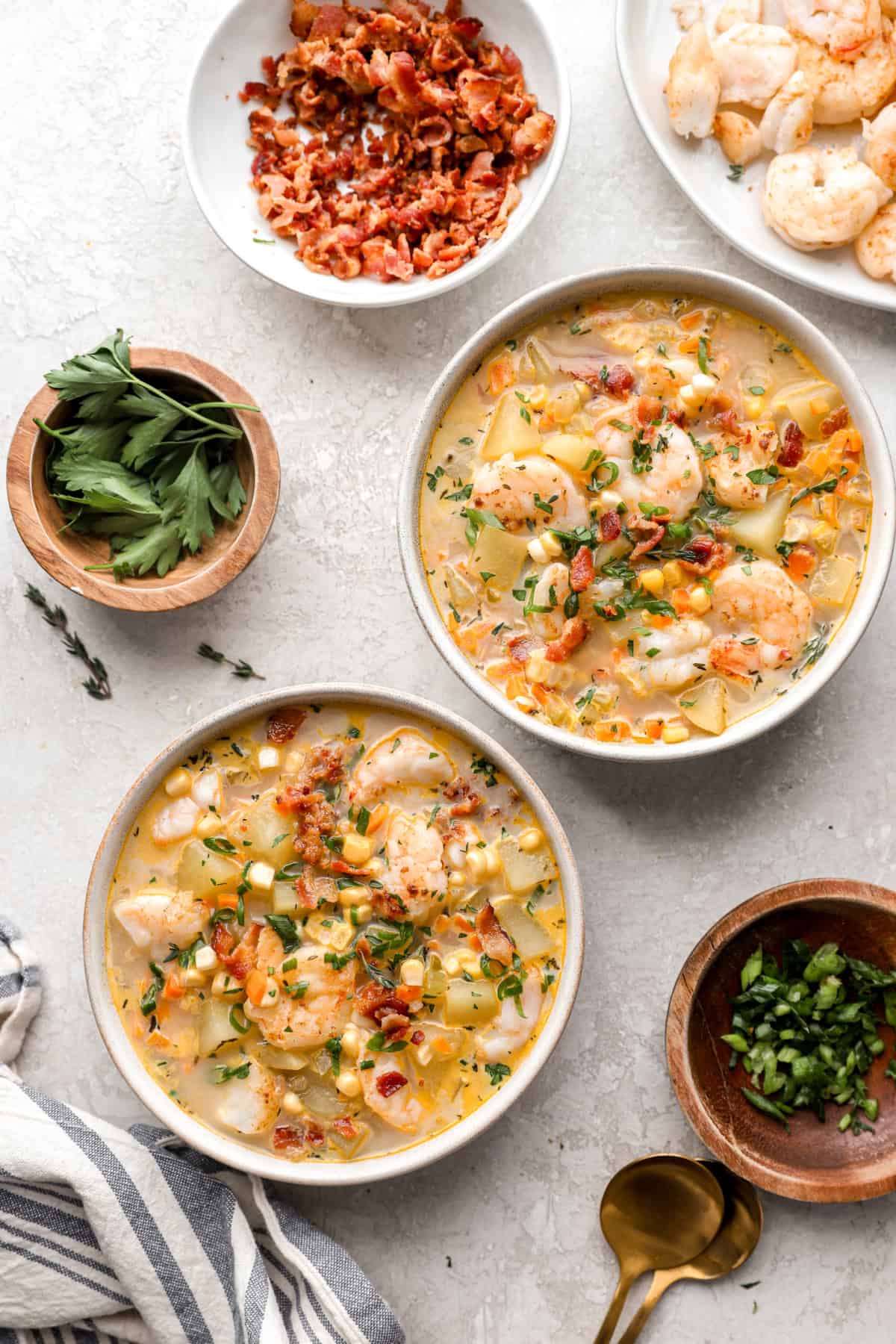 Overhead image of two bowls of creamy potato shrimp and corn chowder. 