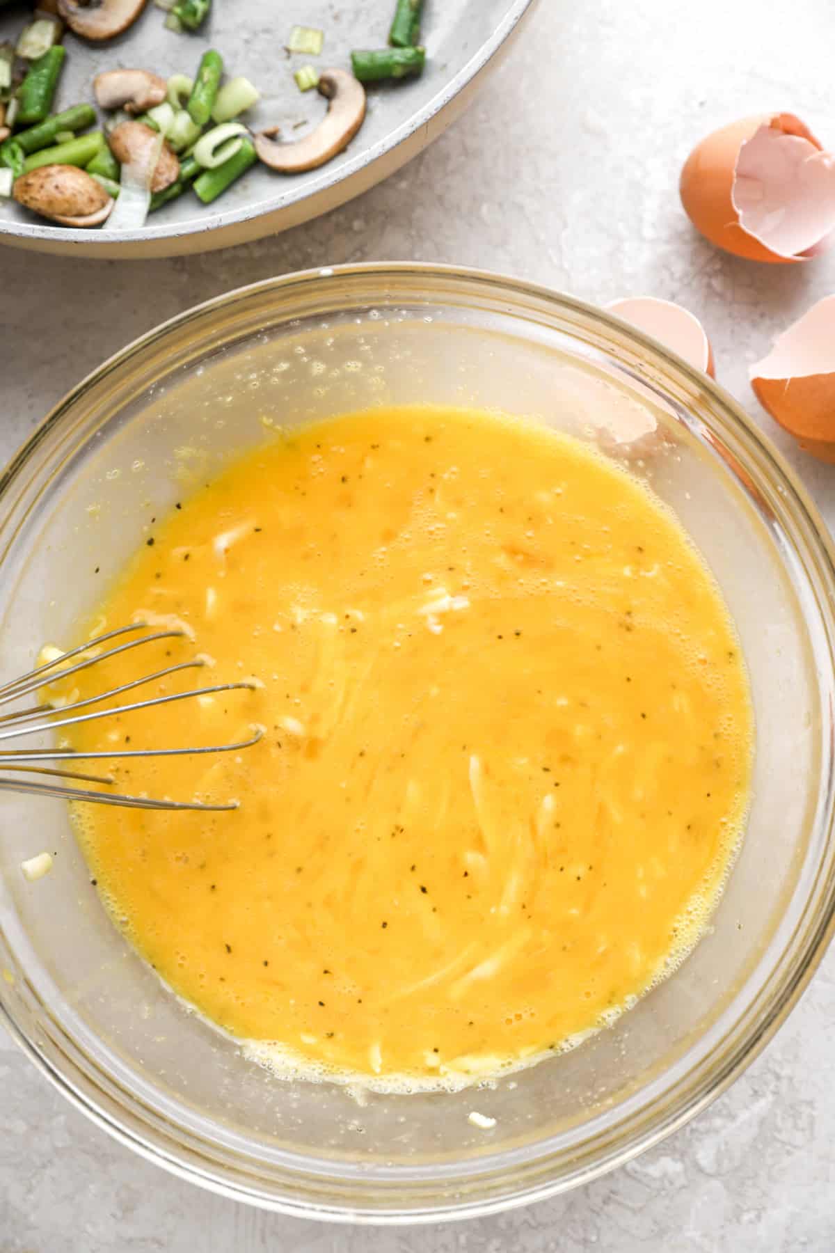 Eggs being whisked in a bowl.