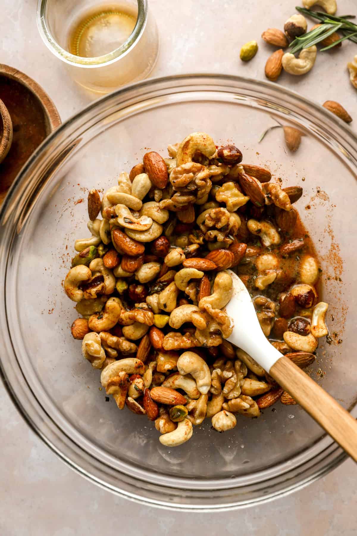 Nuts being tossed in a spice mixture. 