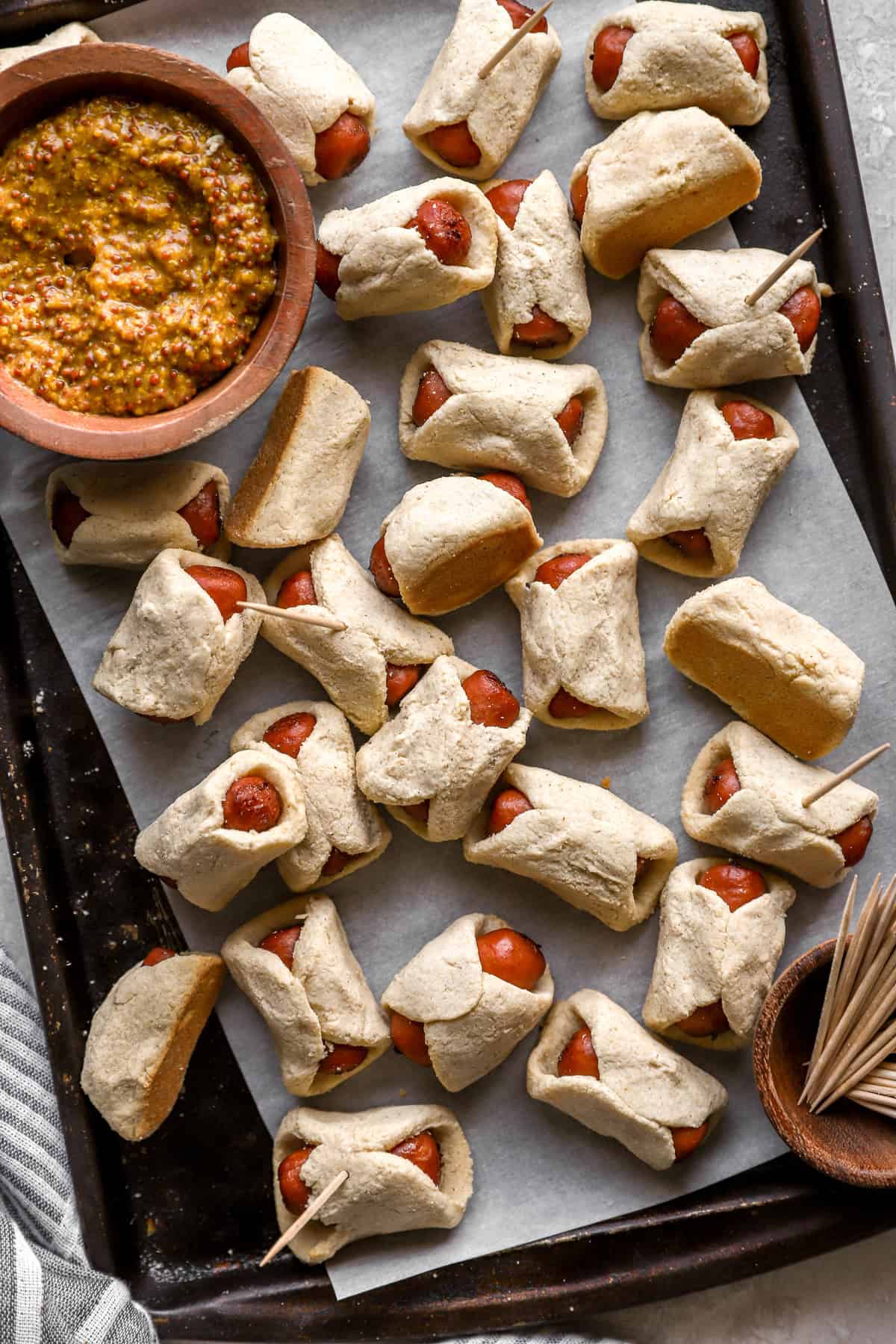 Gluten free pigs in a blanket on a baking sheet. 