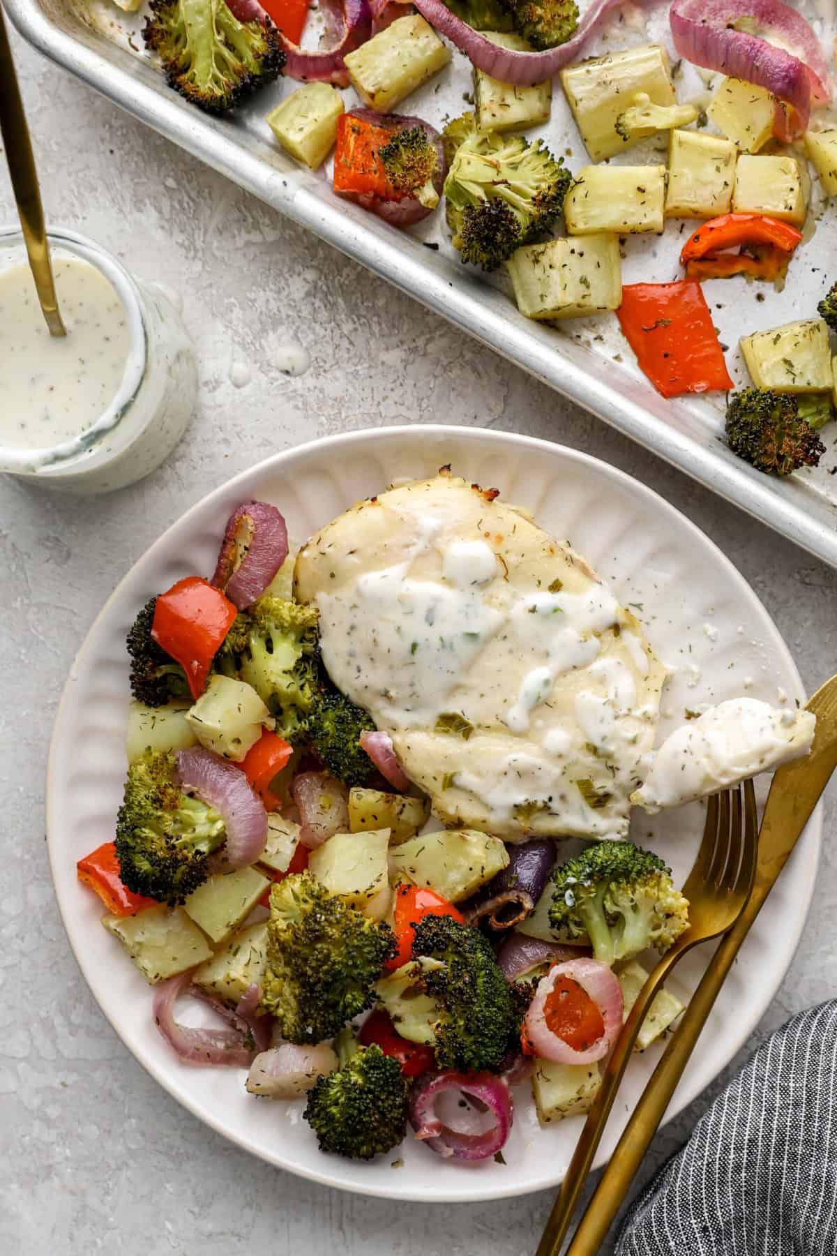 A plate of baked Ranch chicken and veggies. 