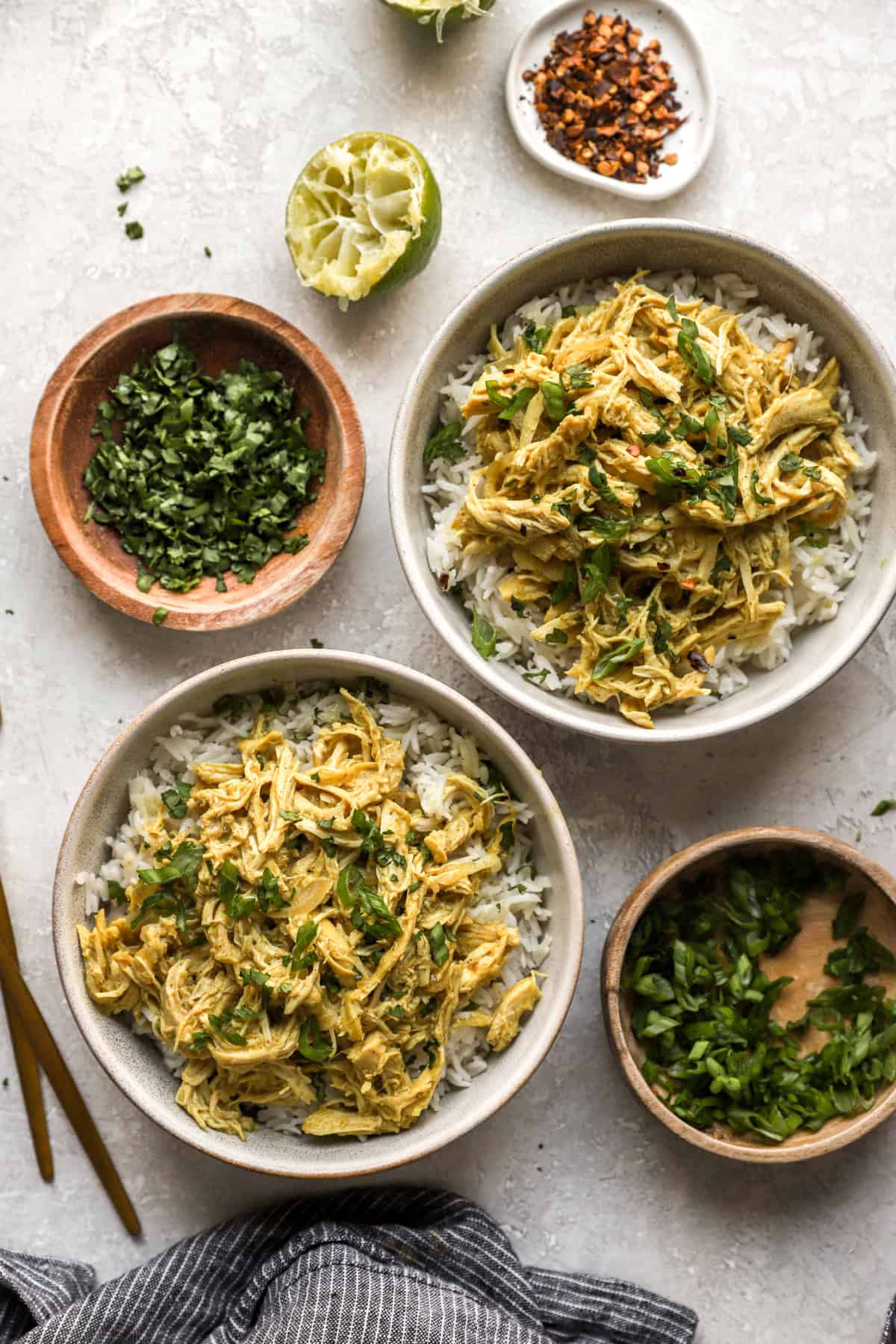 Two bowls of crockpot chicken curry over rice. 