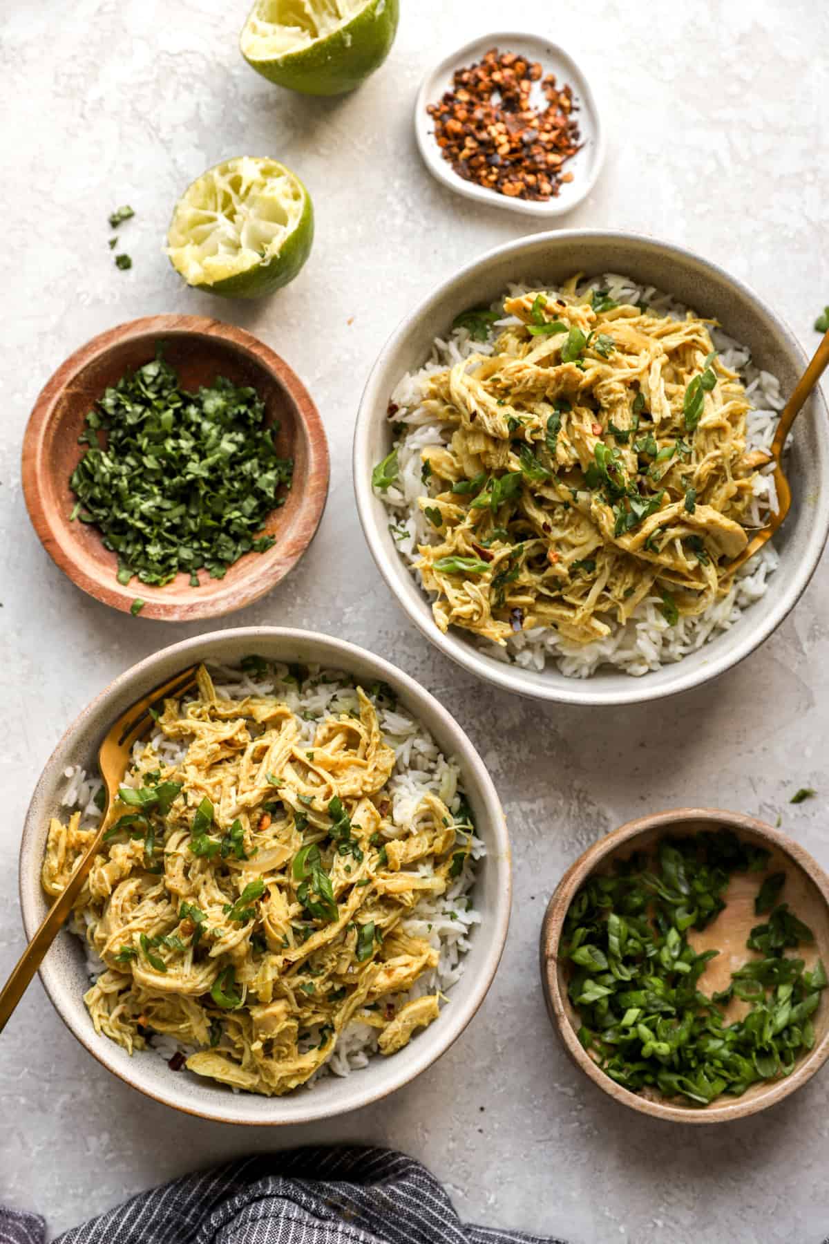 Two bowls of crockpot chicken curry over rice. 