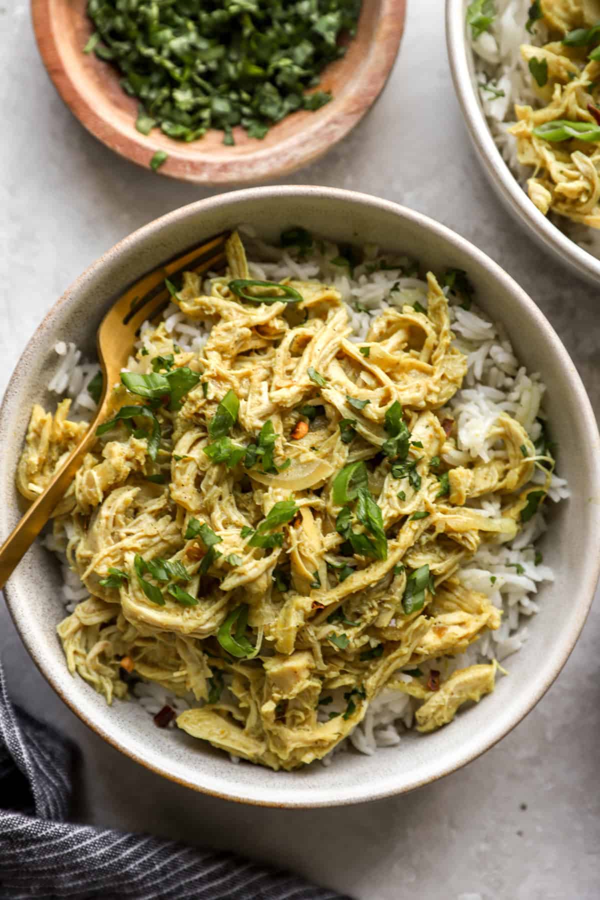 A bowl of slow cooker chicken curry over rice. 